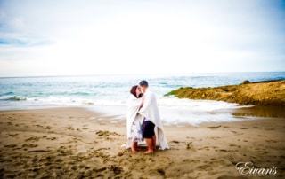 woman in white dress standing on beach during daytime