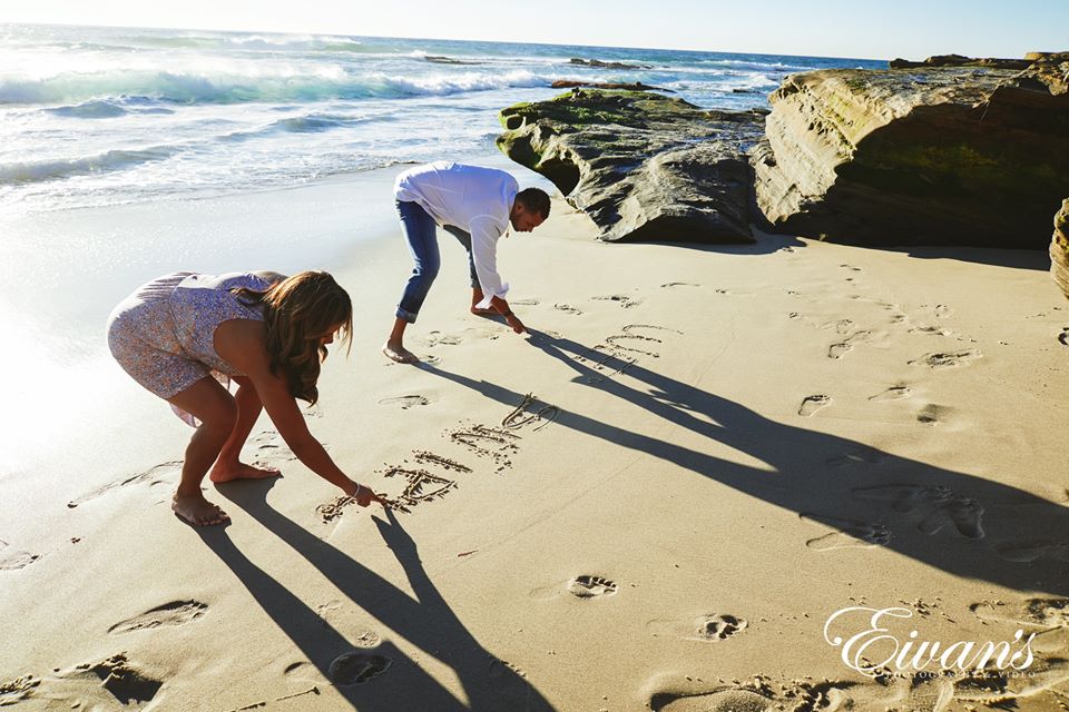 Beach Engagement Photos (246) woman in white t-shirt and pink shorts standing on beach shore during daytime