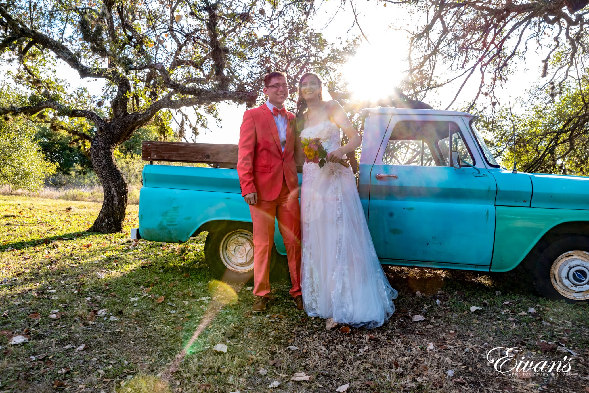 man and woman standing beside blue car during daytime