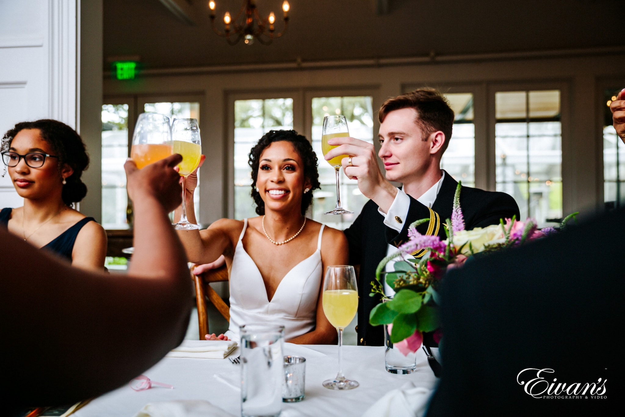 woman in white halter top holding bouquet of flowers