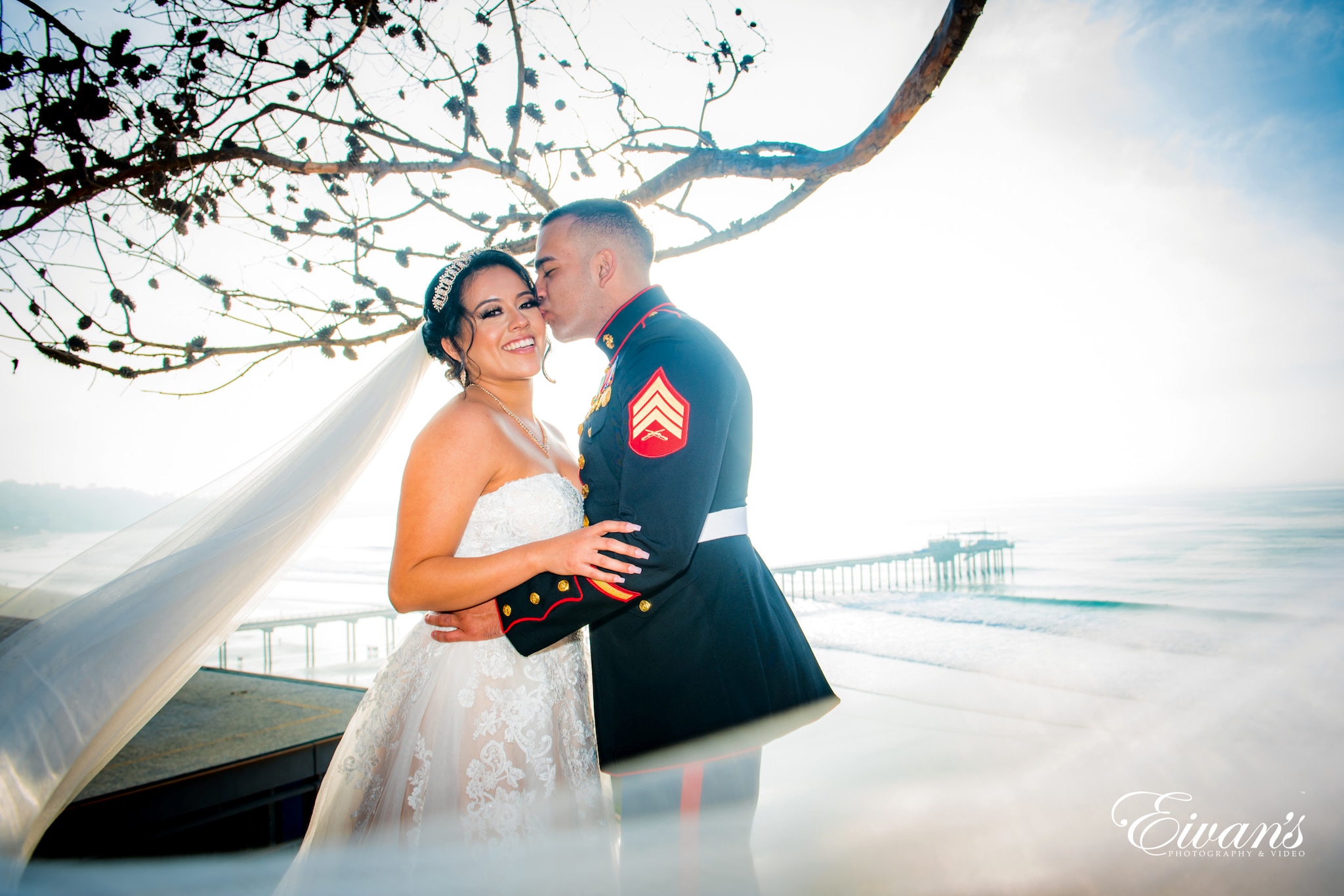 beach man in black tank top and woman in white wedding dress standing on snow covered ground