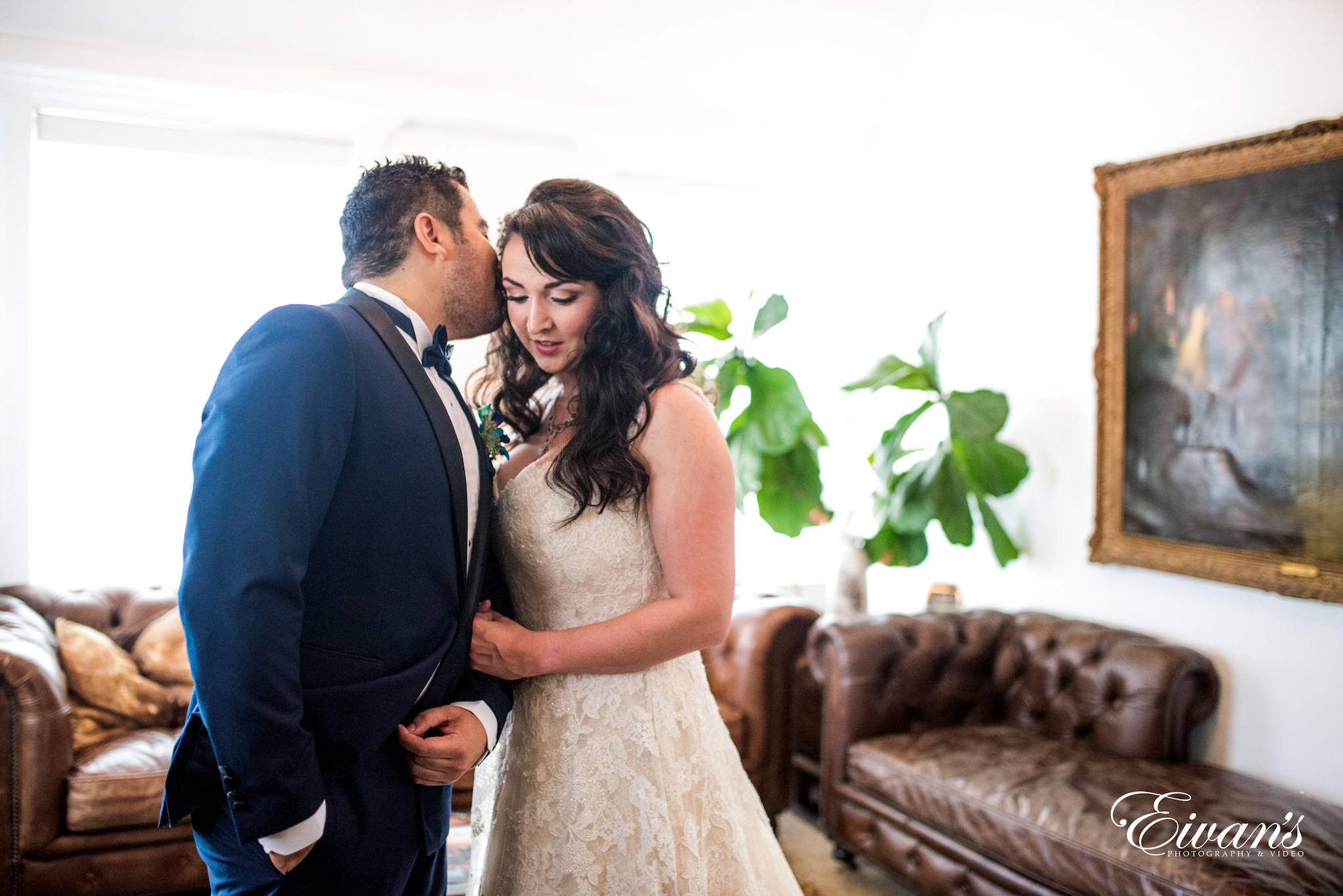 man in black suit and woman in white wedding dress