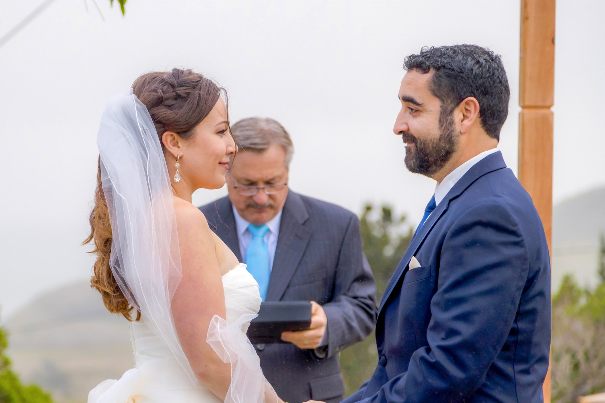 man in blue suit jacket holding woman in white wedding dress