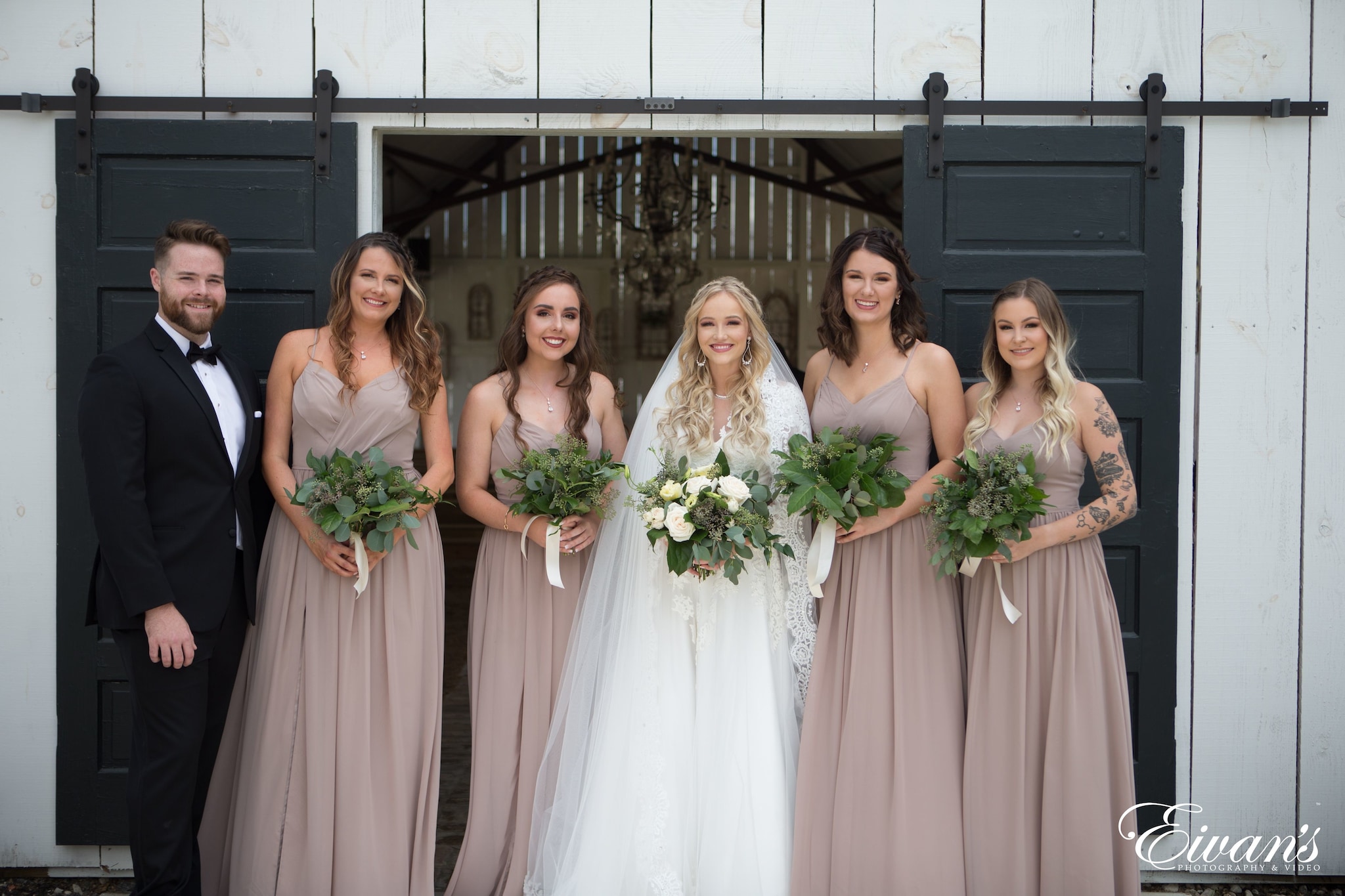 woman in white wedding gown holding bouquet of flowers