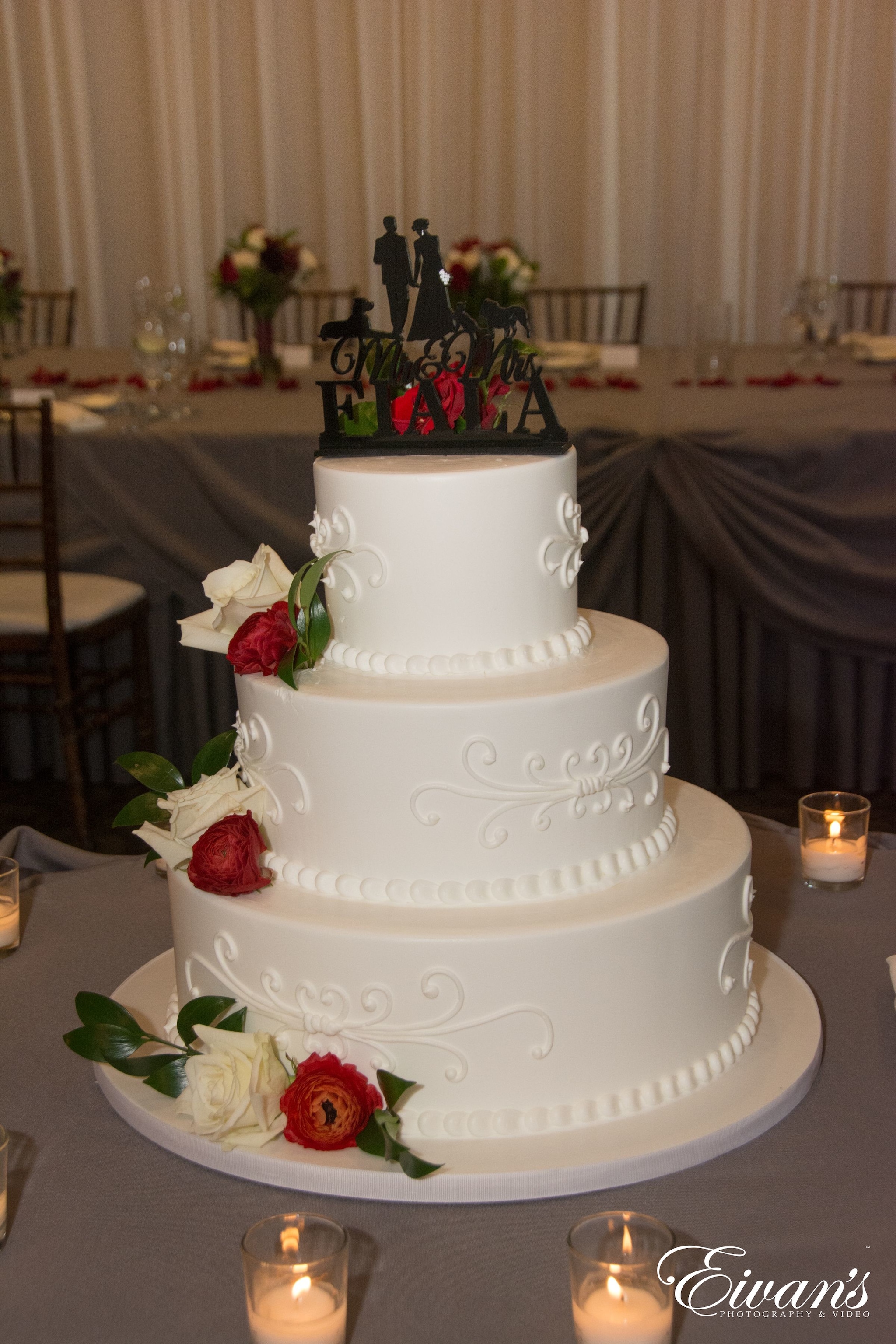 white 3 tier cake with red roses