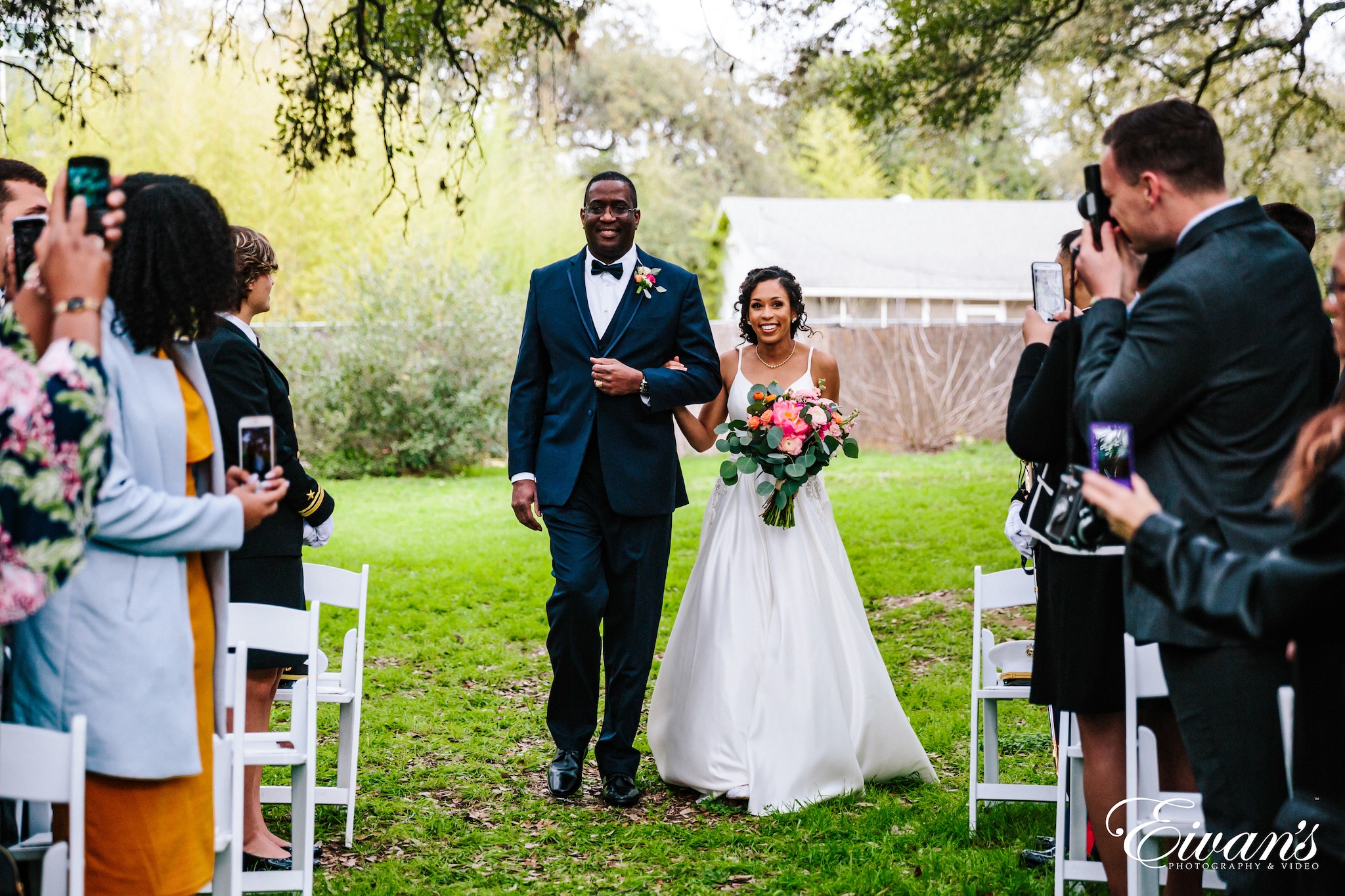 man in blue suit jacket standing beside woman in white wedding gown