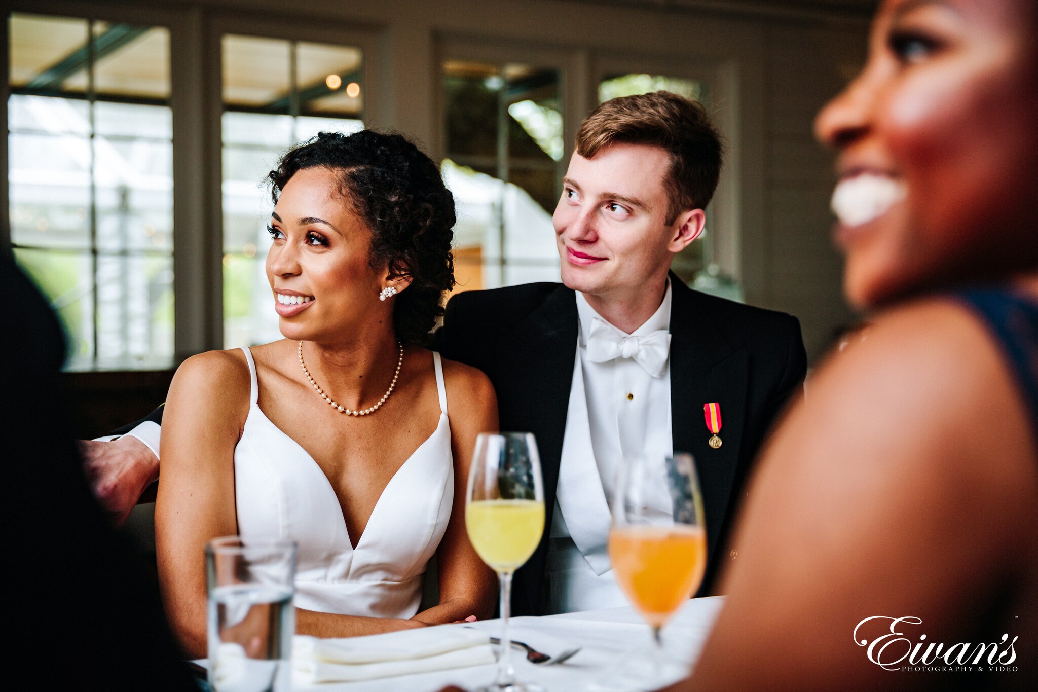 woman in white halter top holding clear wine glass
