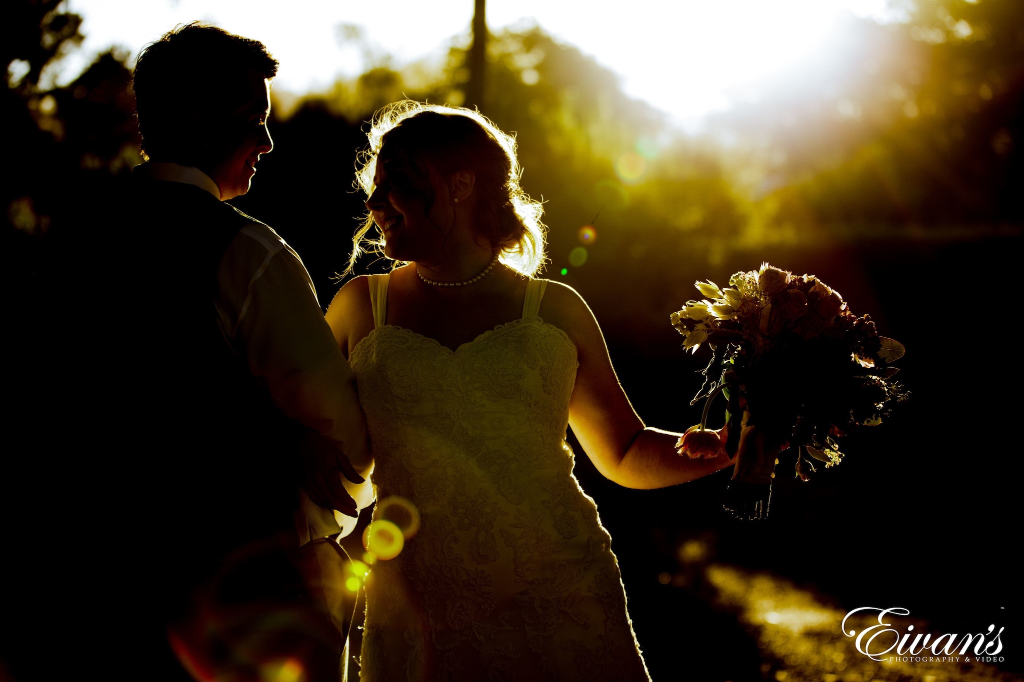 woman in white sleeveless dress holding bouquet of flowers