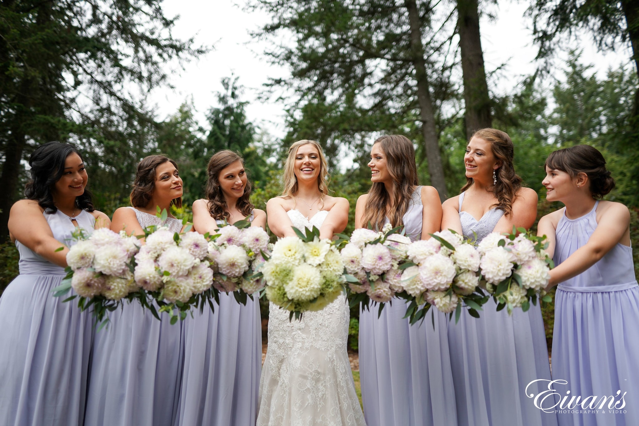 women in white dress standing near green trees during daytime