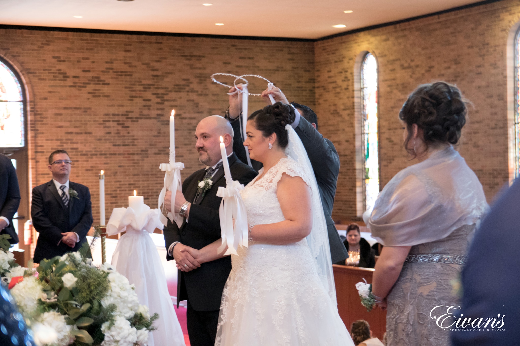 bride and groom holding white candles