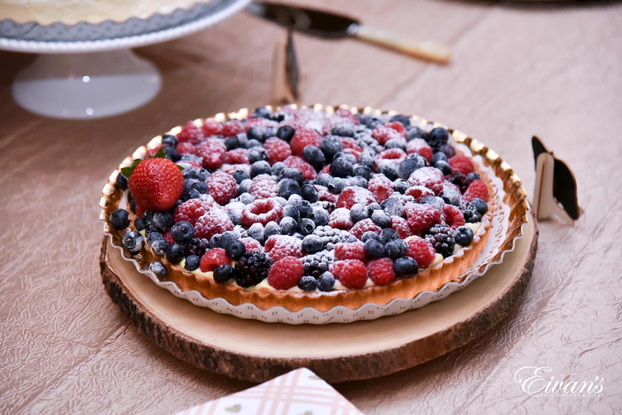 white and red round cake on brown wooden round tray
