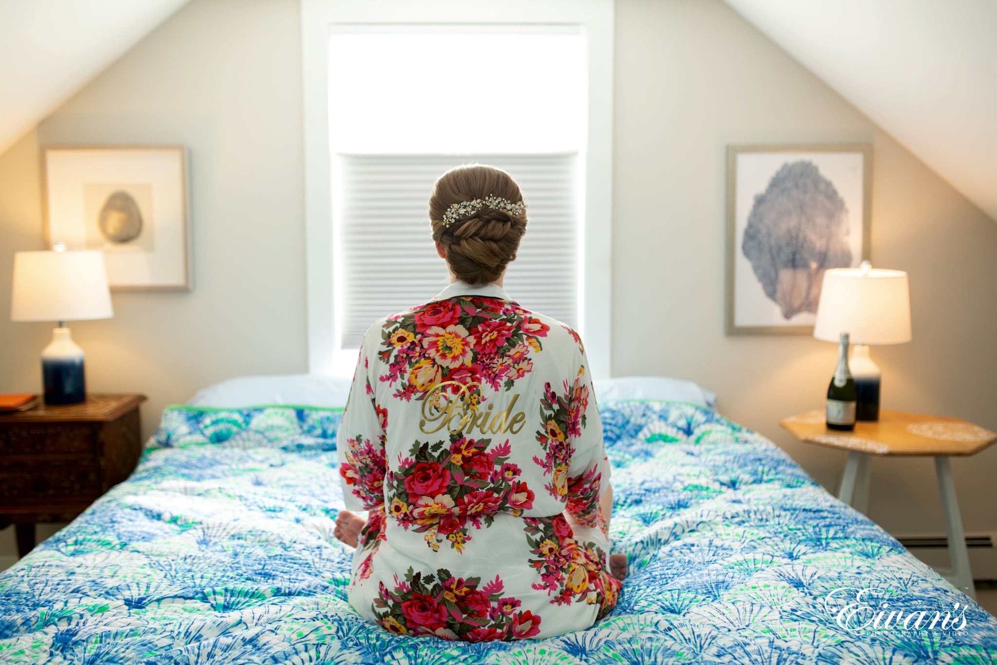woman in white red and green floral long sleeve shirt sitting on bed