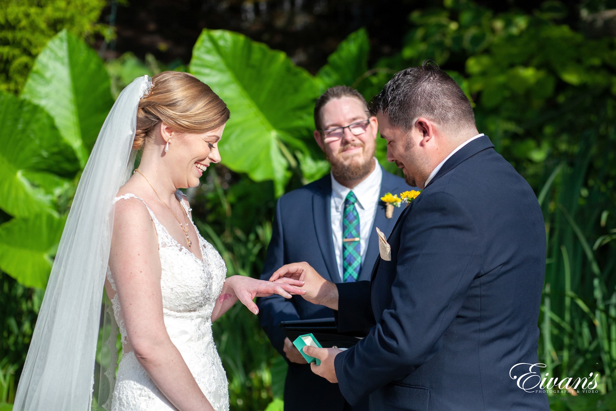 man in black suit jacket kissing woman in white wedding dress