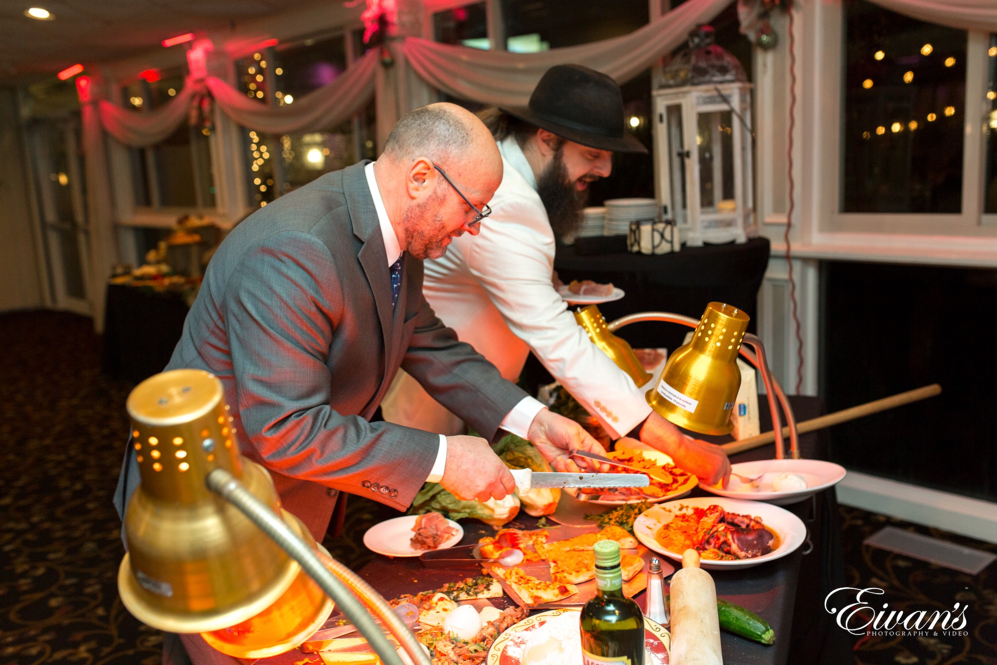 man in brown suit jacket sitting beside man in white dress shirt