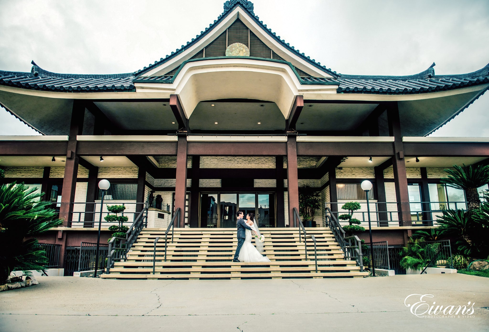 people walking on stairs near brown and white building during daytime