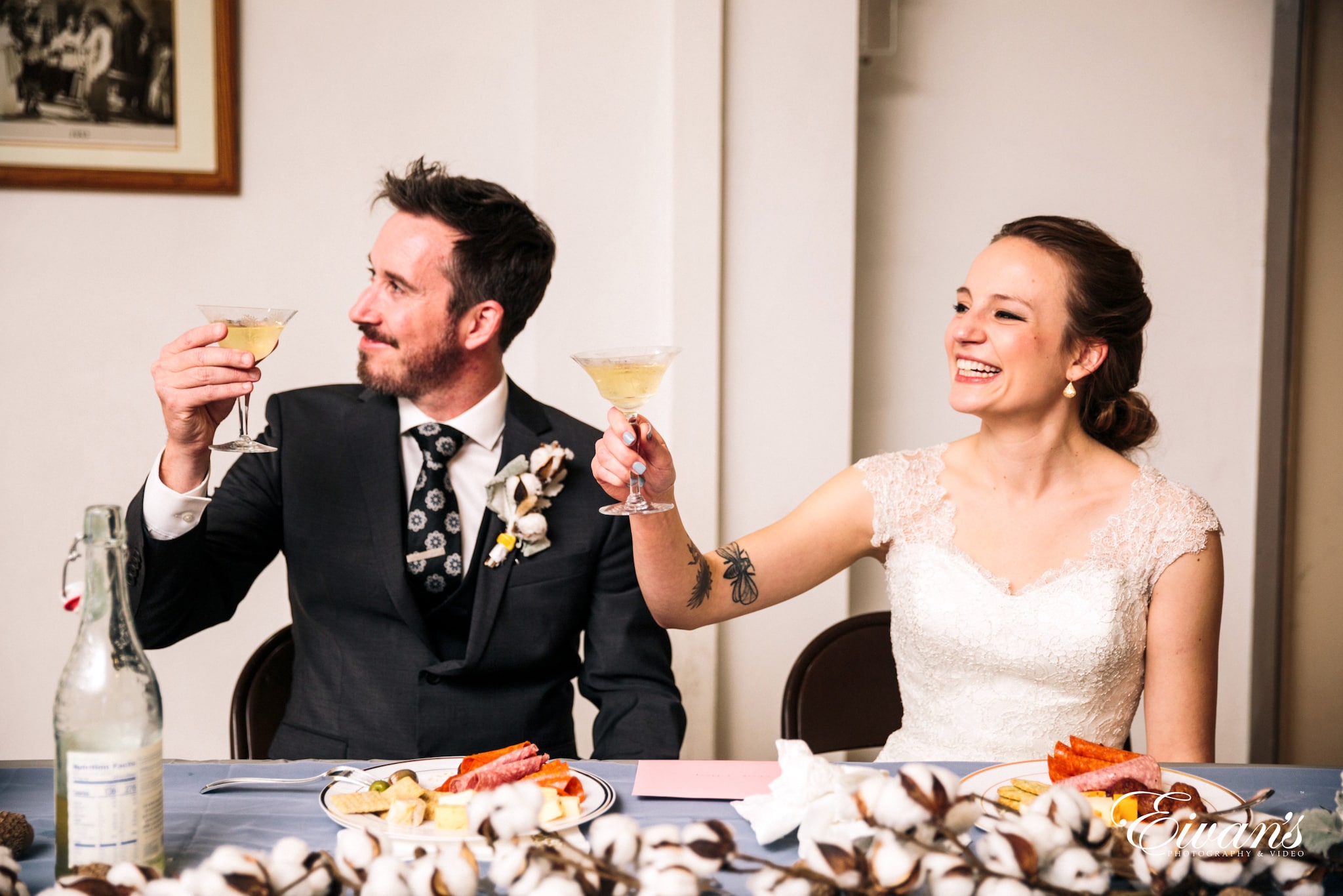 man in black suit jacket holding clear wine glass