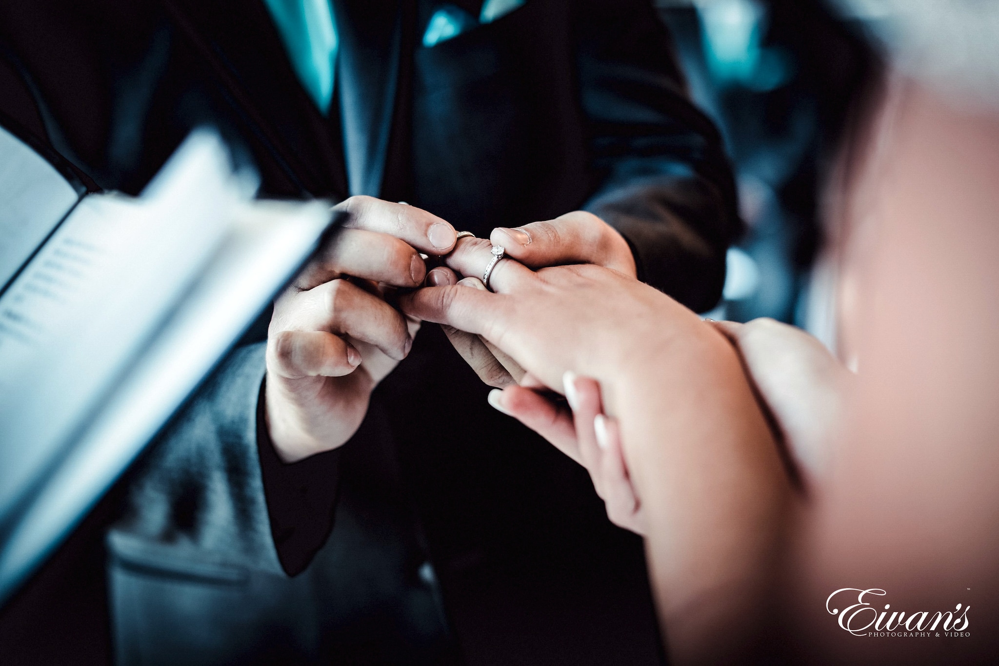 man in black suit holding hands of woman in black dress