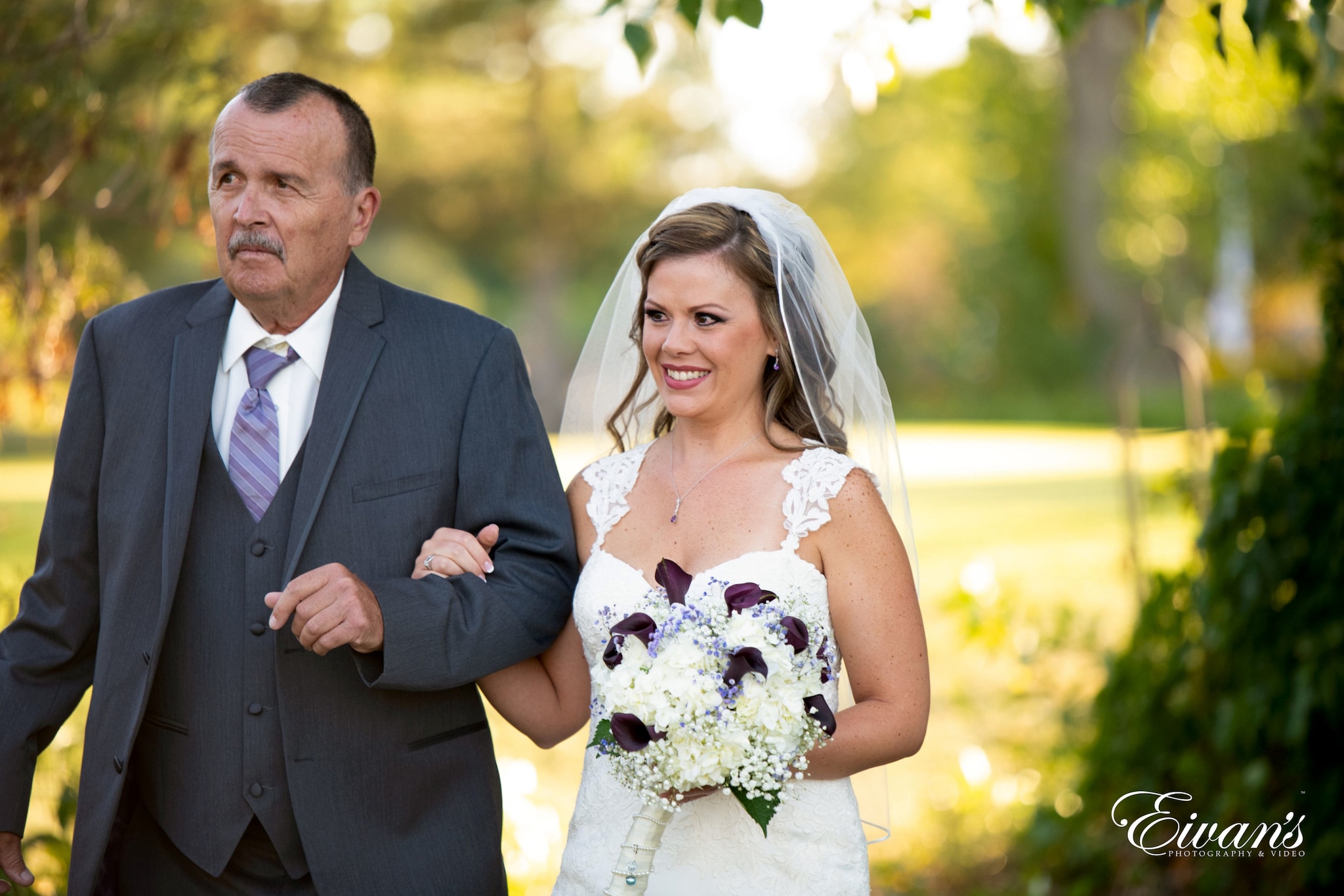 man in black suit and woman in white wedding dress