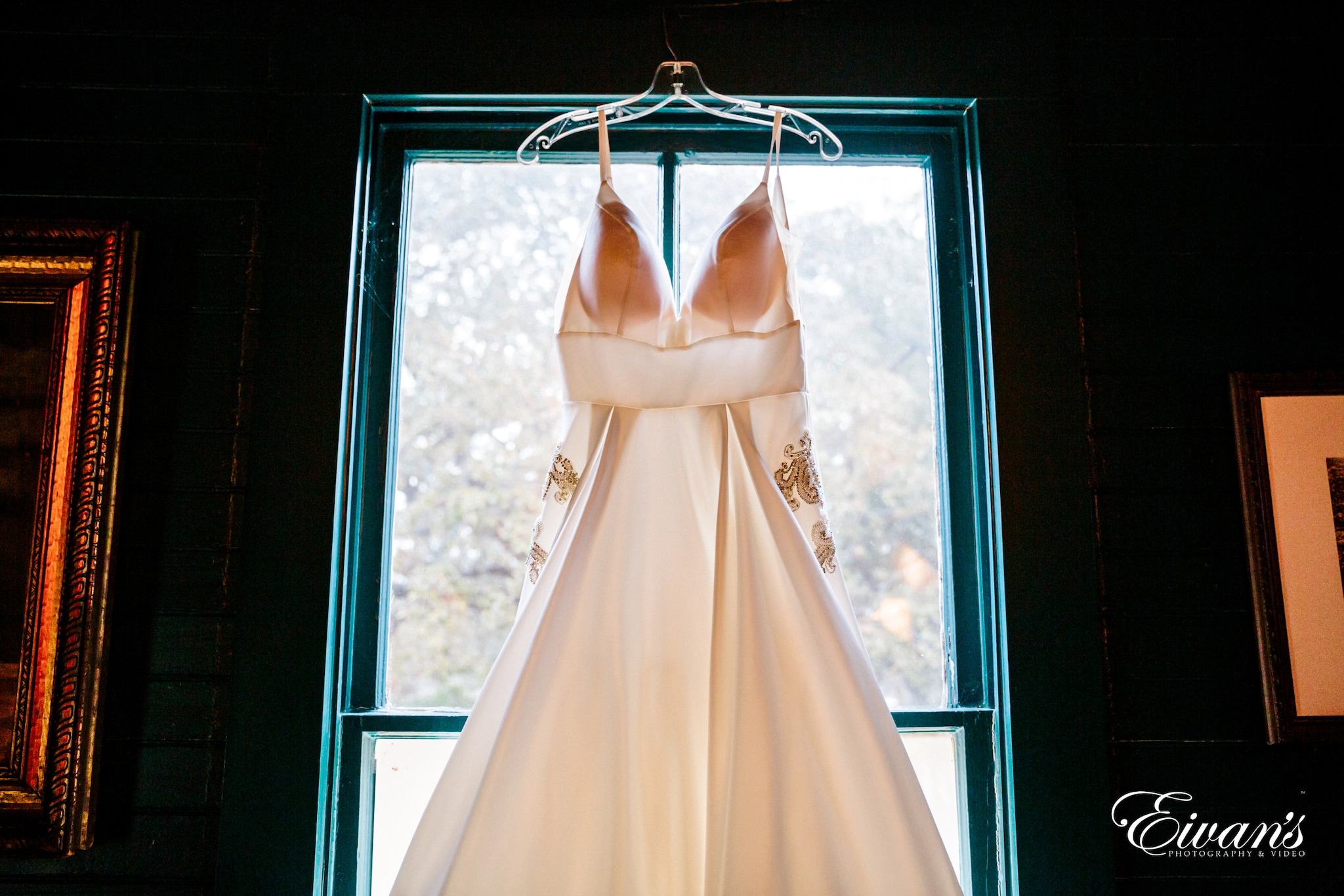 white wedding gown on brown wooden frame