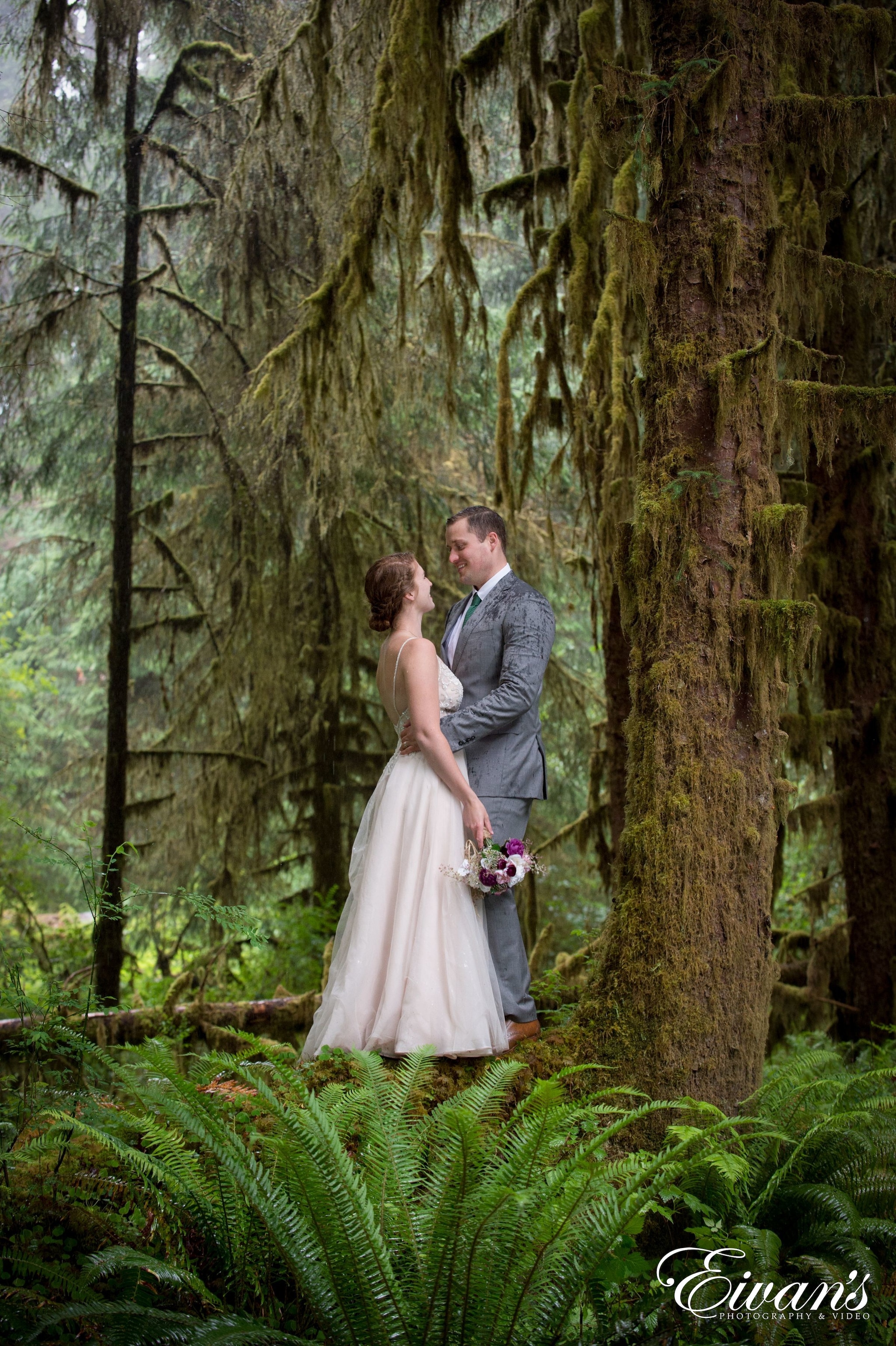 man and woman in wedding dress standing on forest during daytime
