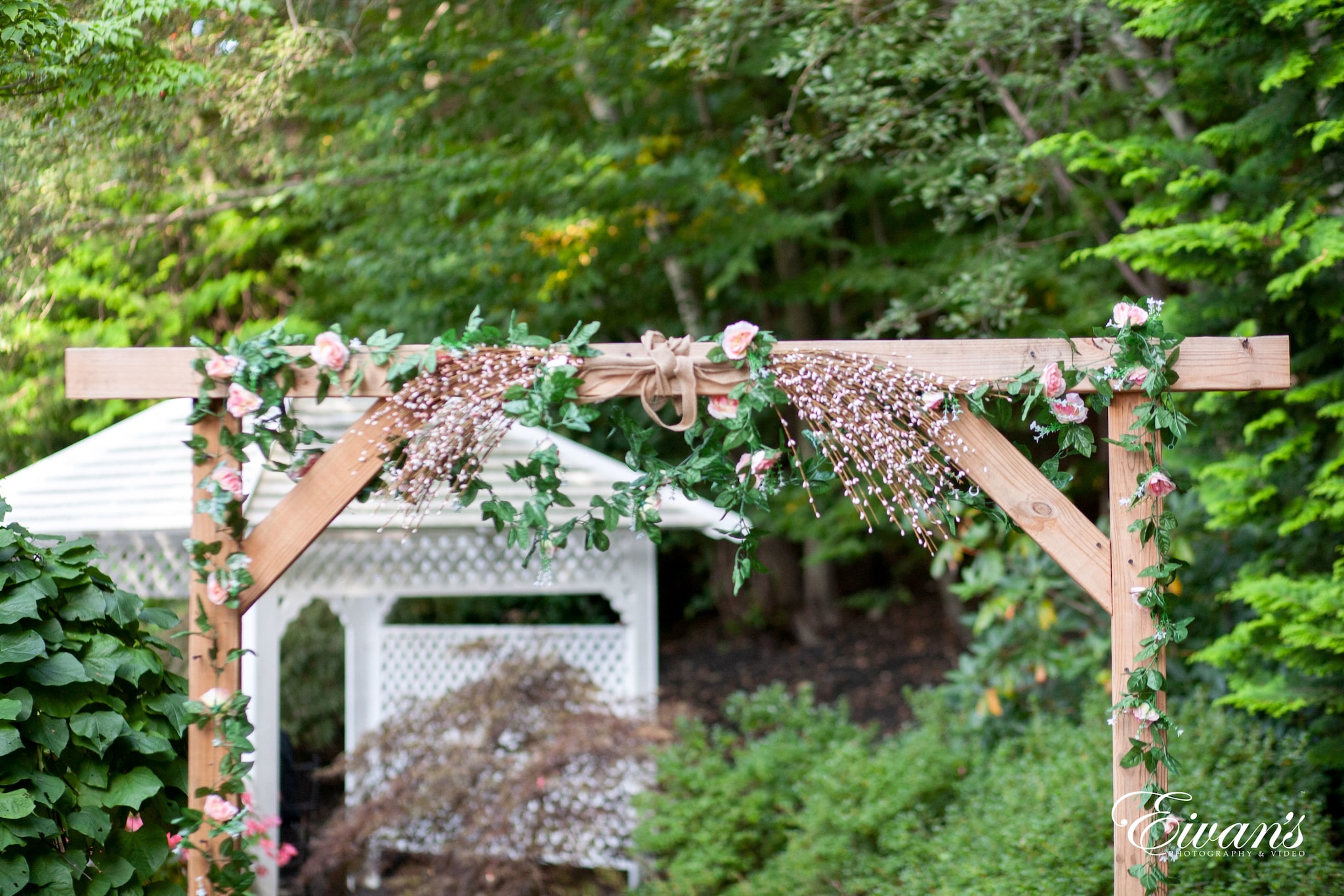 brown wooden fence with green plants