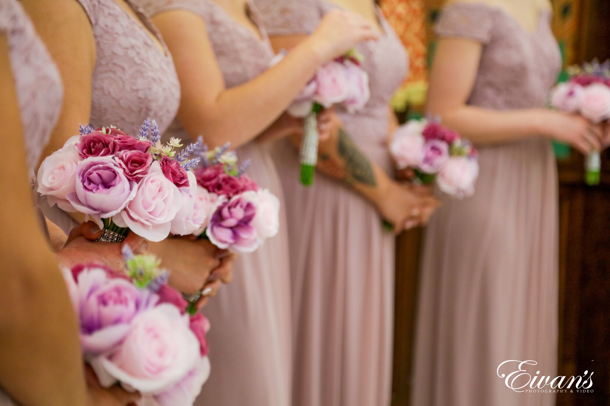 woman in white floral wedding dress holding pink rose bouquet