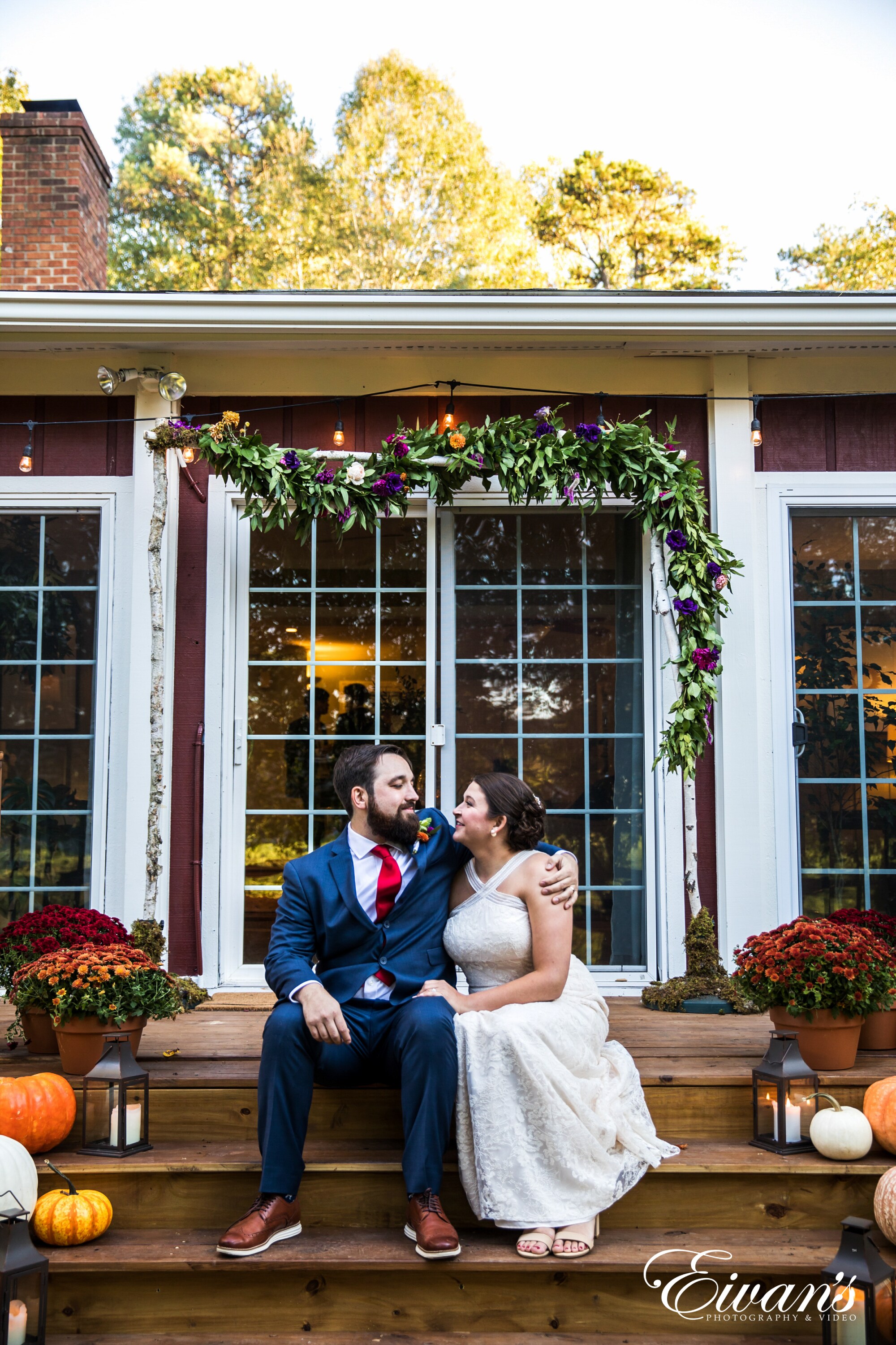 man and woman sitting on brown wooden bench