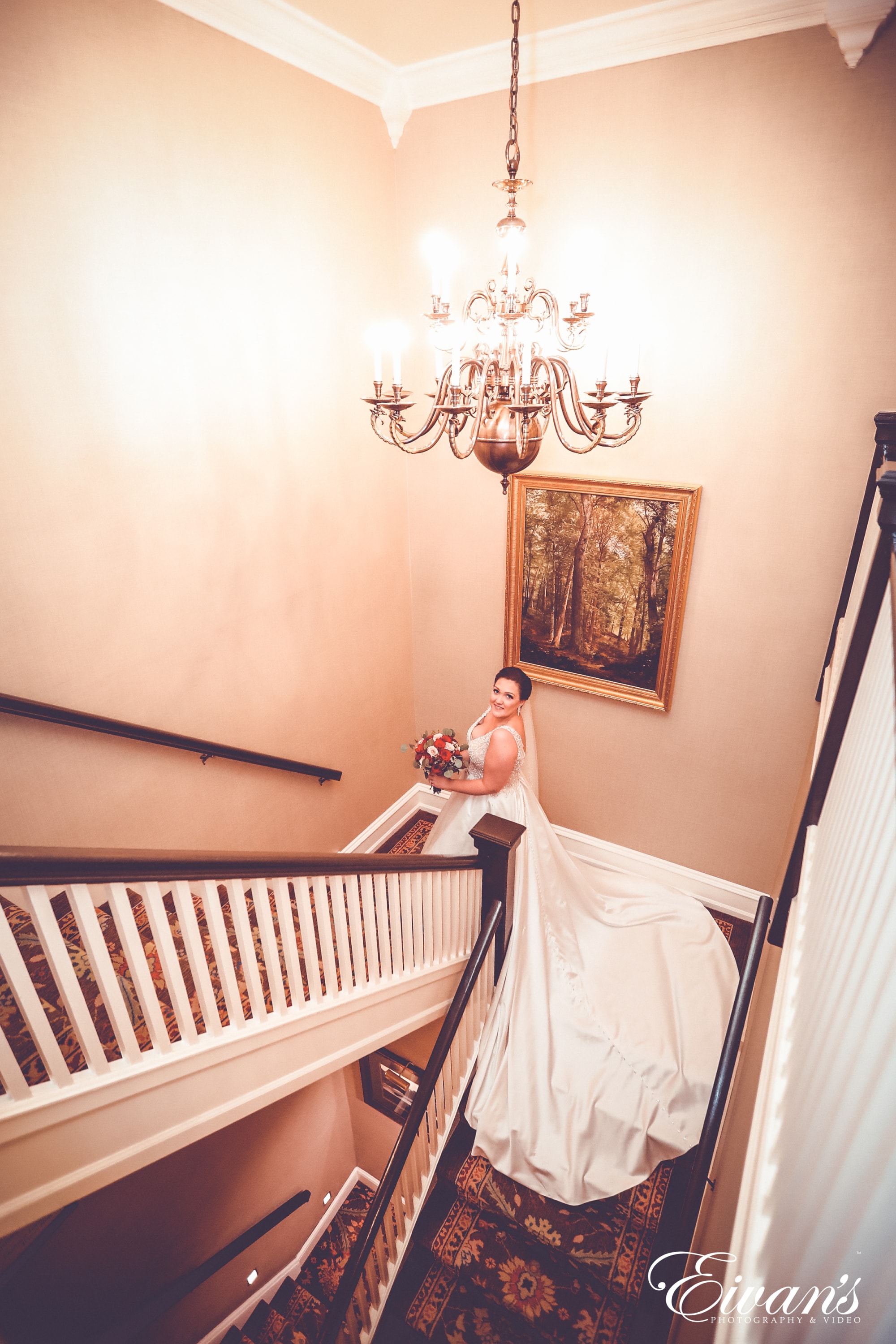 woman in white wedding gown holding baby in white dress