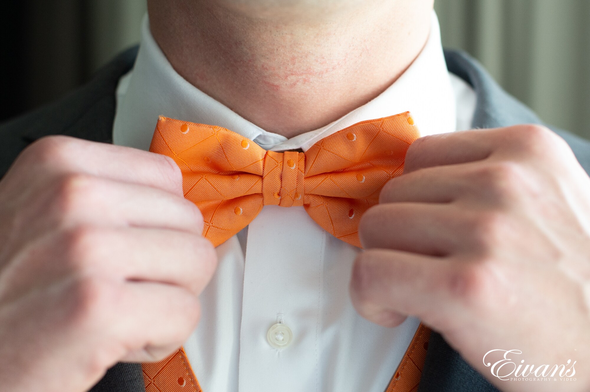 man in white dress shirt with red bowtie