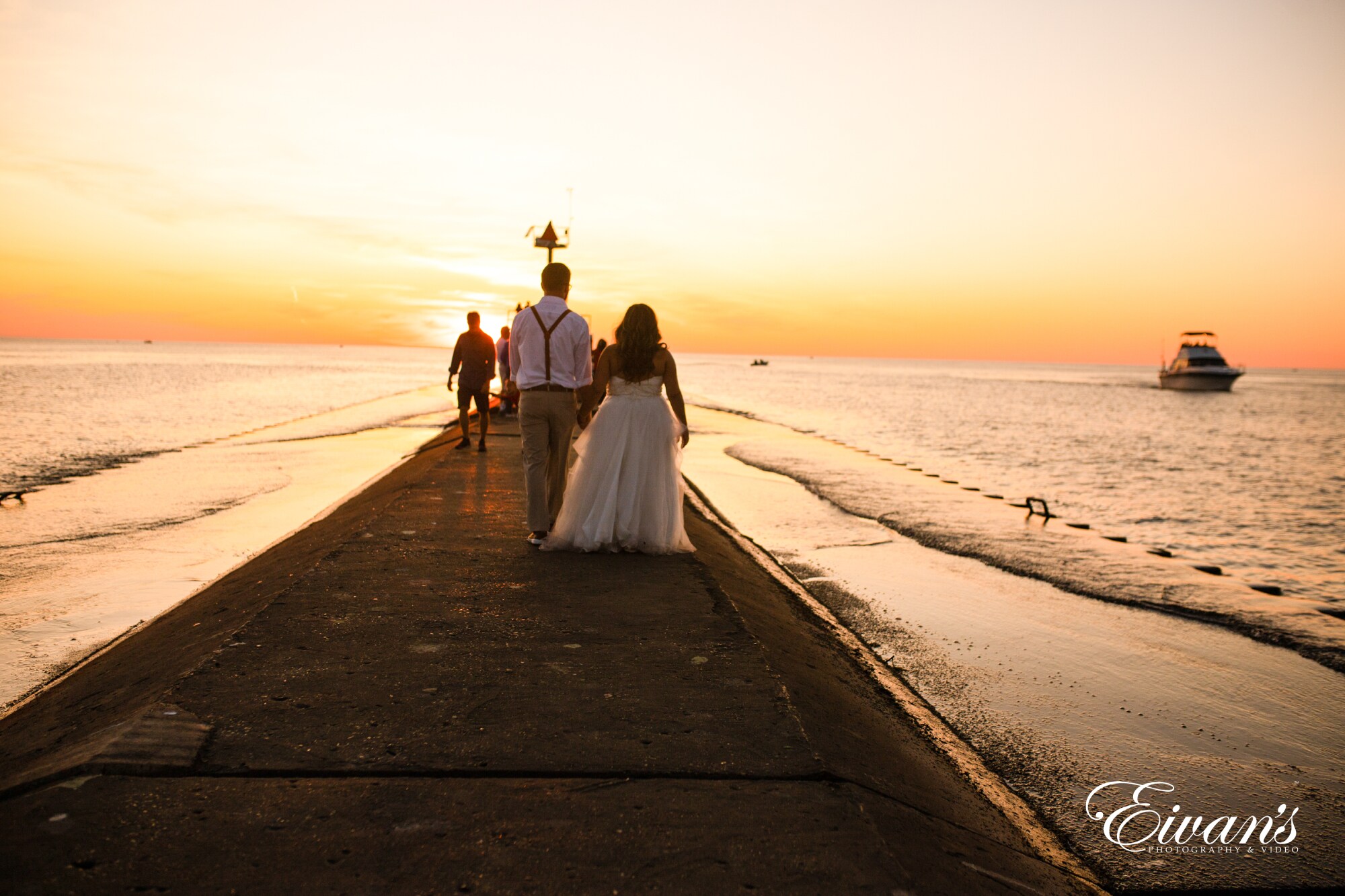 Couple Walking On Beach During Sunset Couple Walking On Beach During Sunset