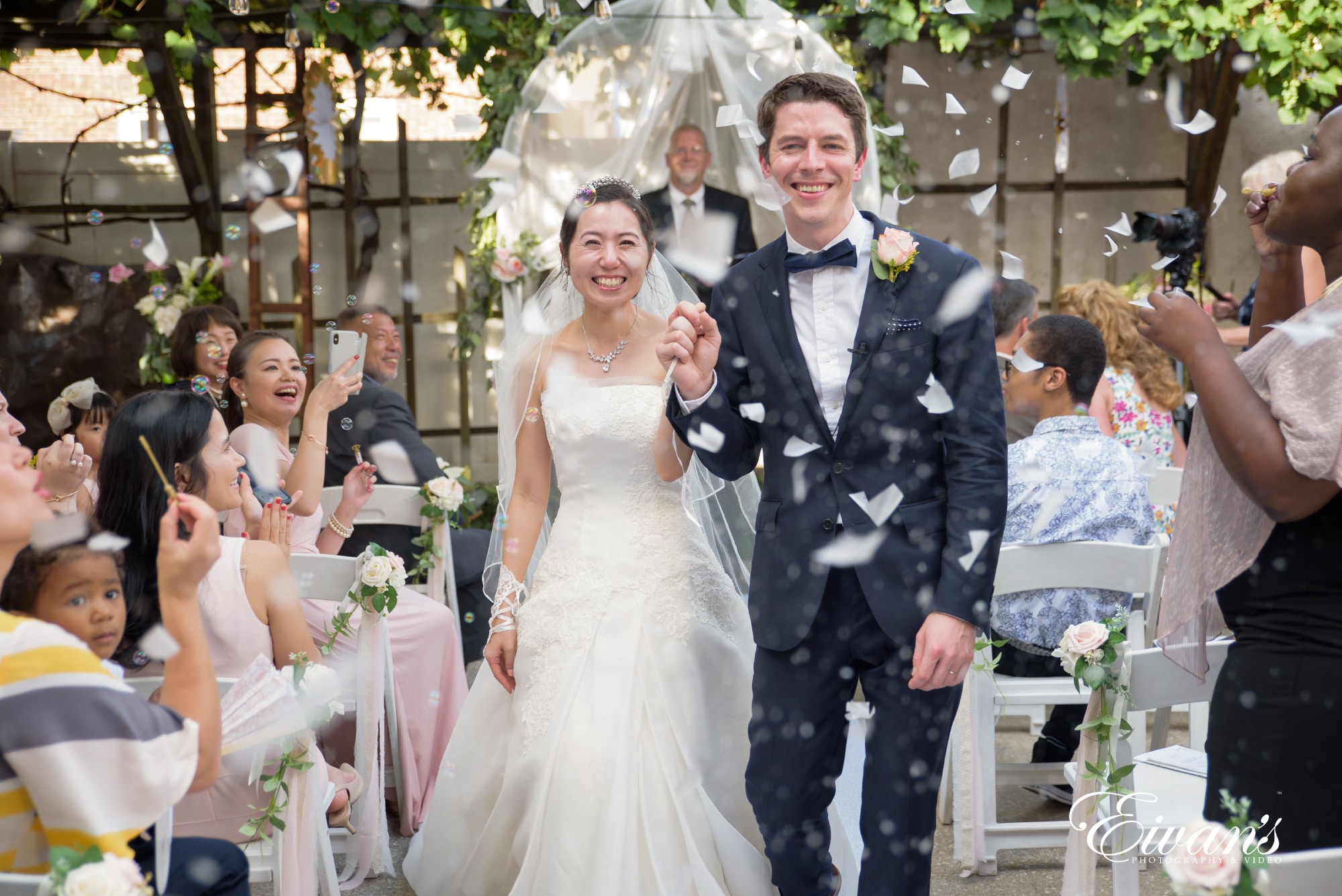 Man In Black Suit Walking Down The Aisle Beside Woman In White Wedding Dress Man In Black Suit Walking Down The Aisle Beside Woman In White Wedding Dress