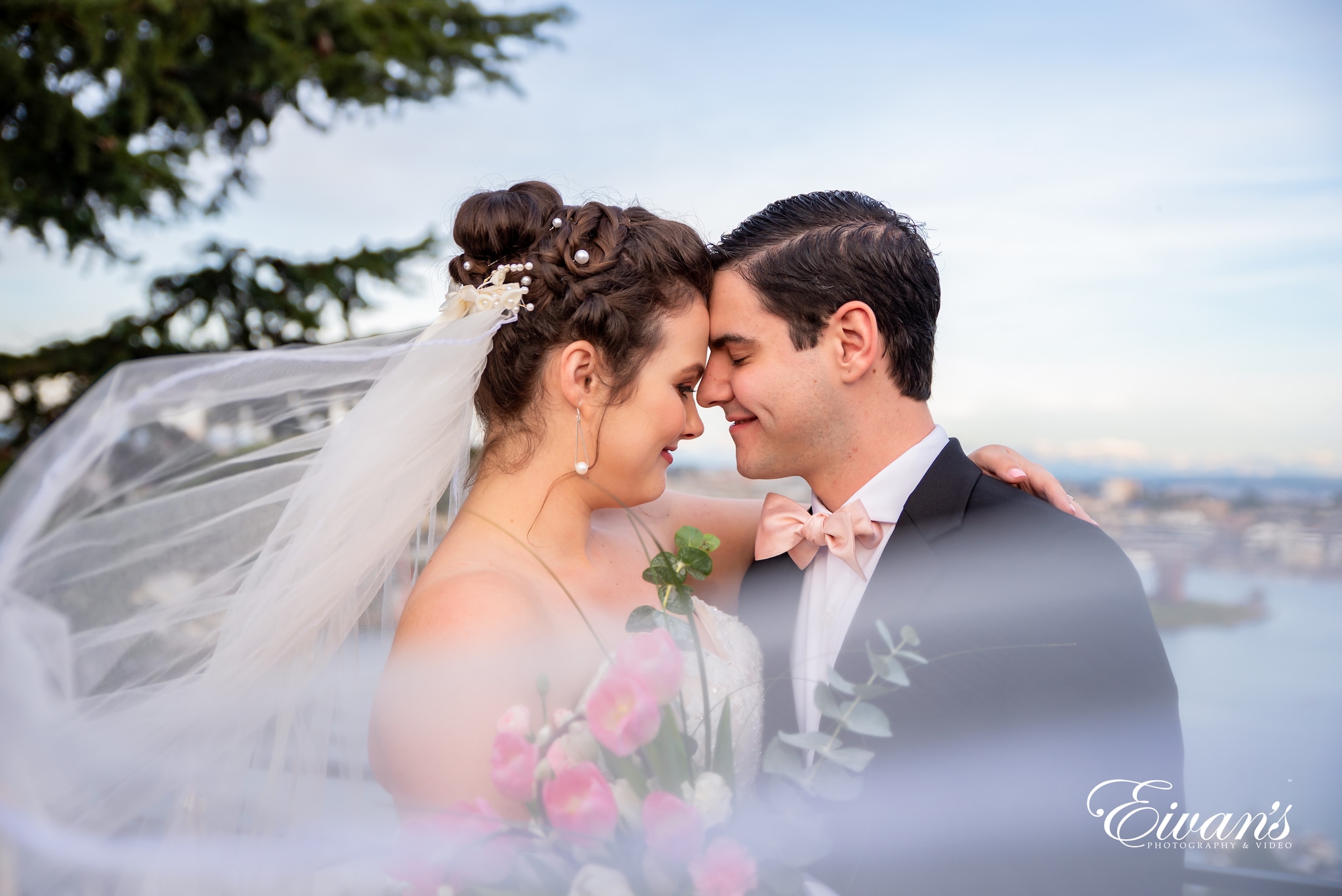 man in black suit kissing woman in white wedding dress