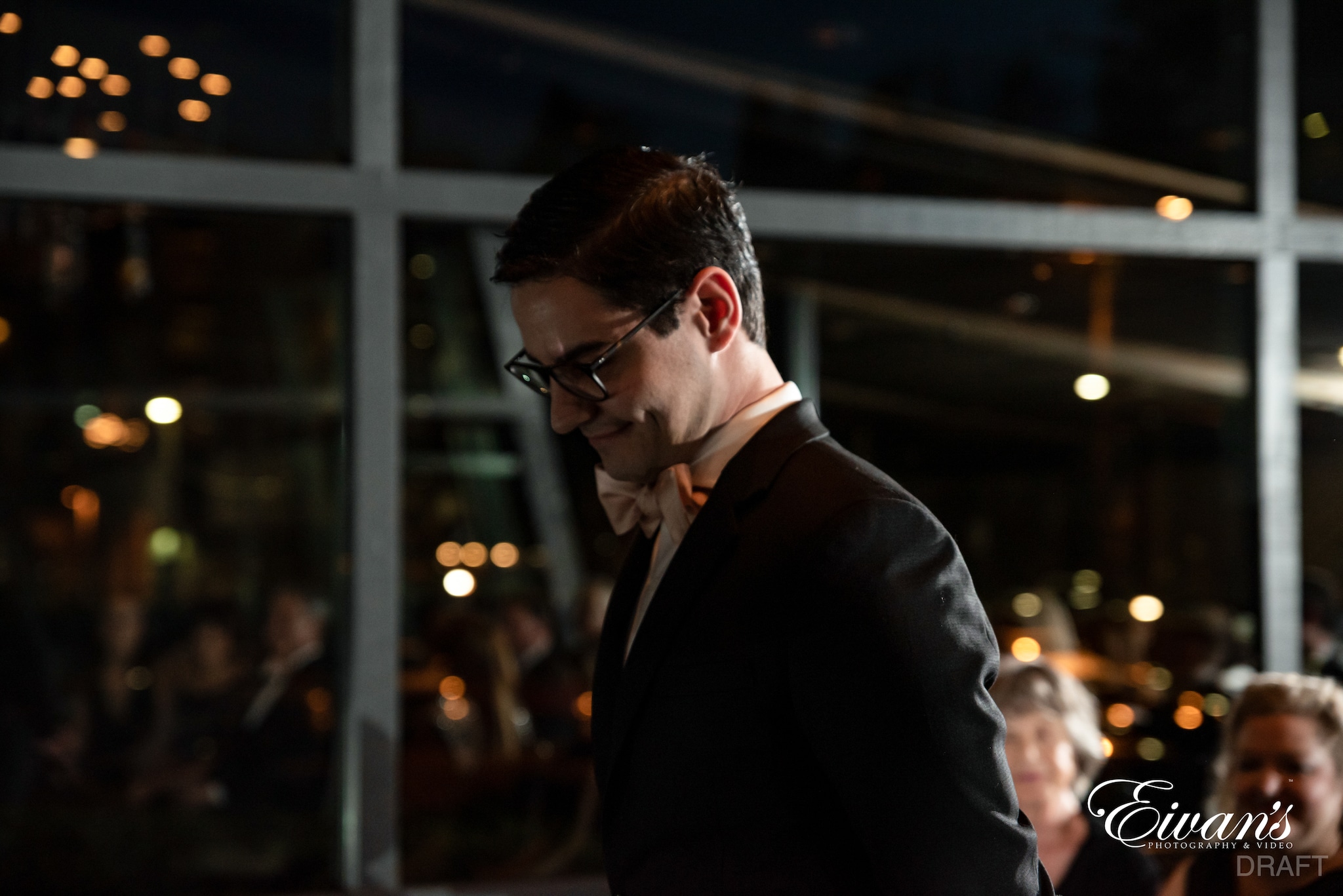 man in black suit jacket wearing black framed eyeglasses