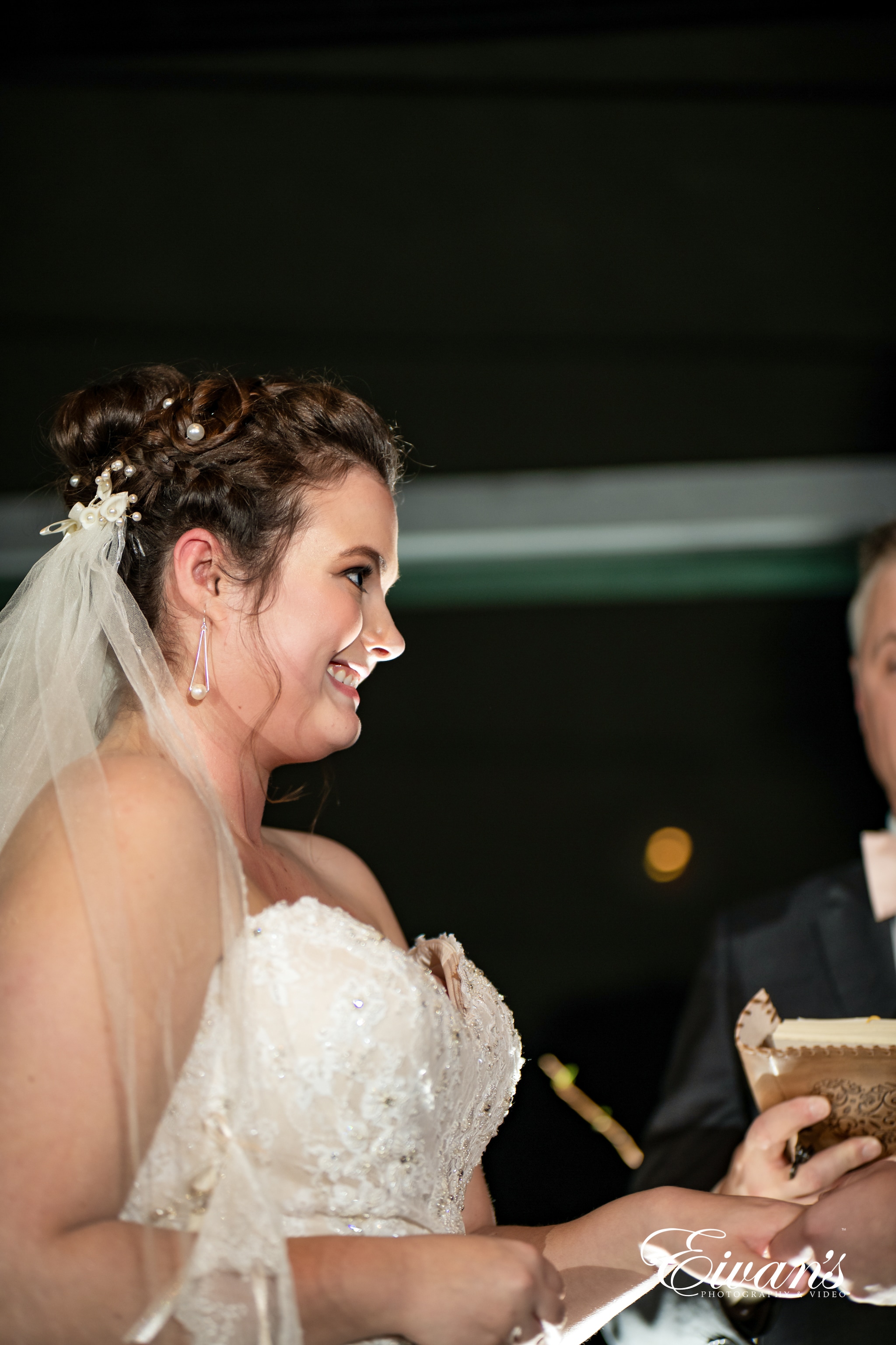 woman in white floral wedding dress smiling