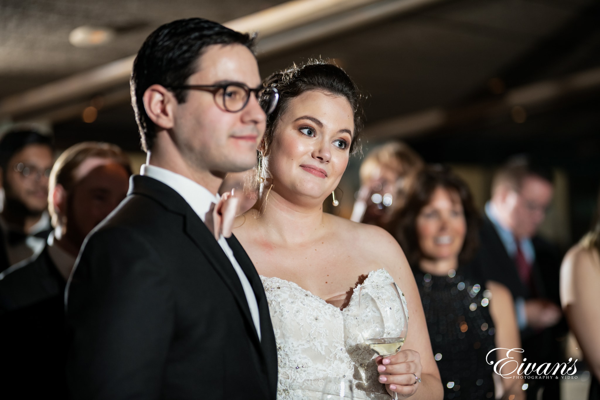 woman in white floral wedding dress beside man in black suit