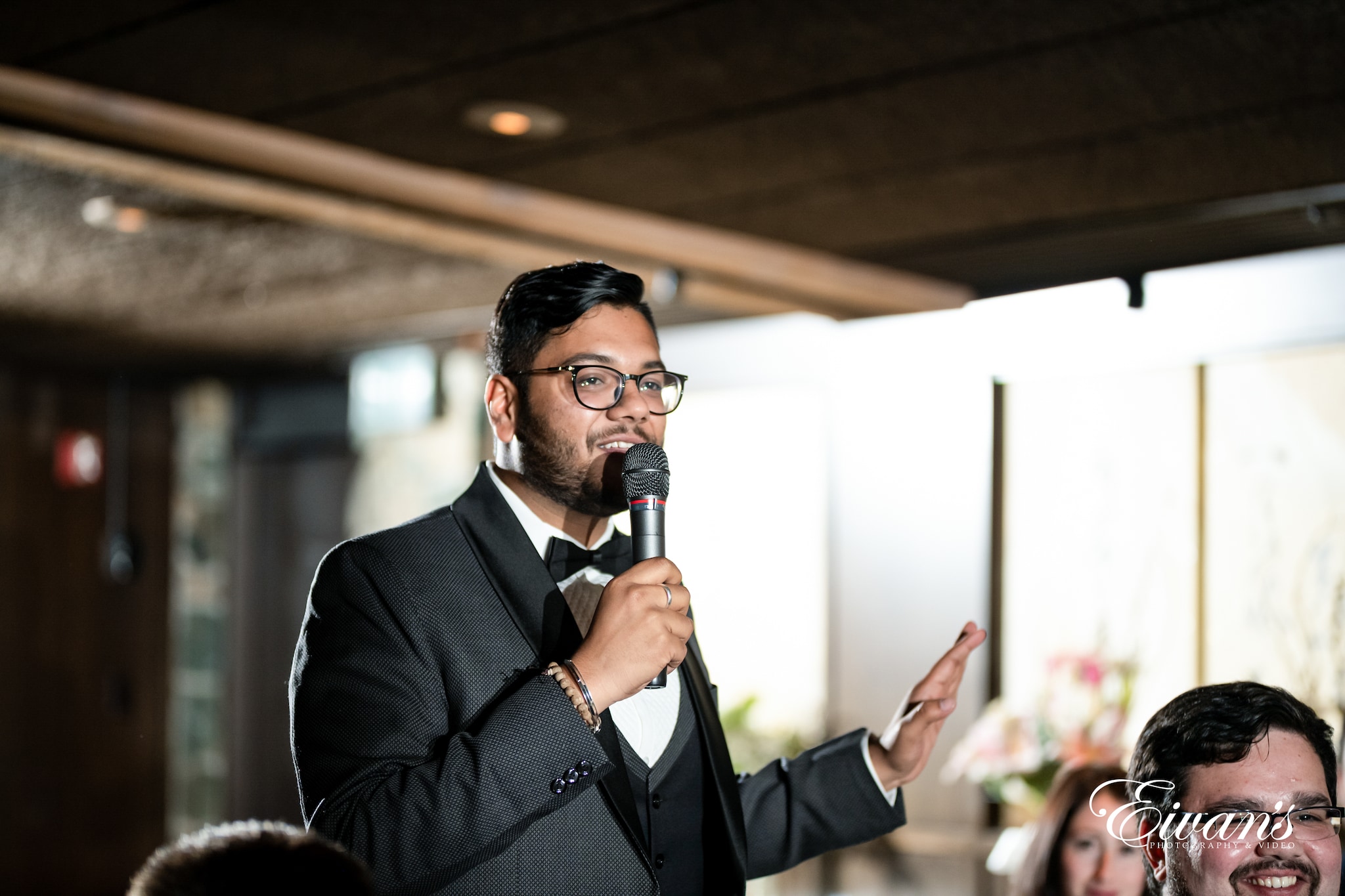 man in black suit singing