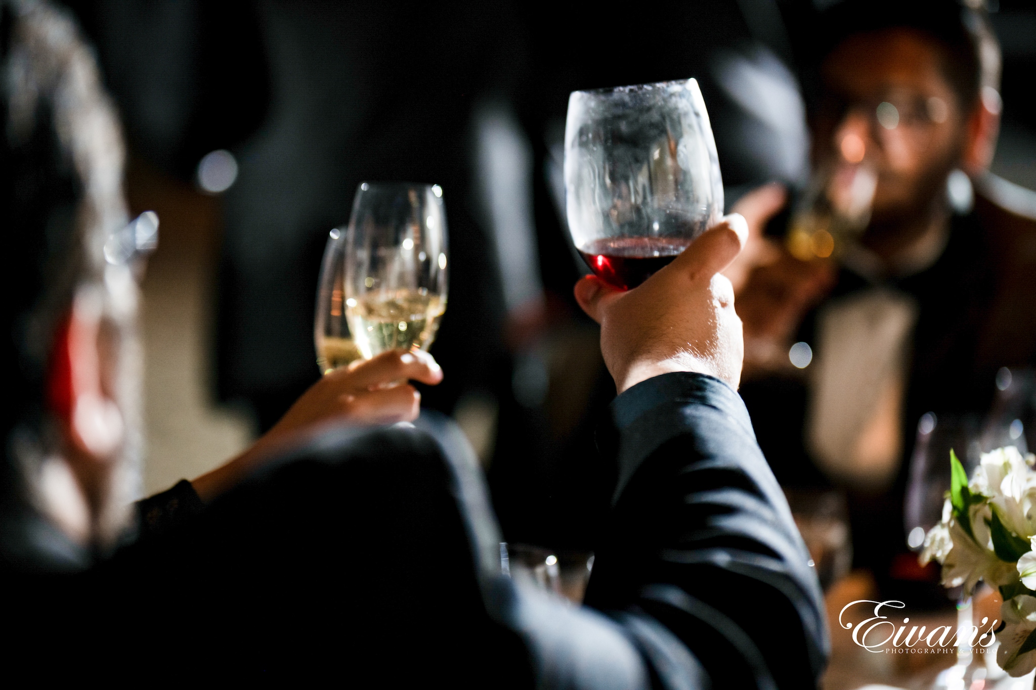 man in black long sleeve shirt holding clear wine glass