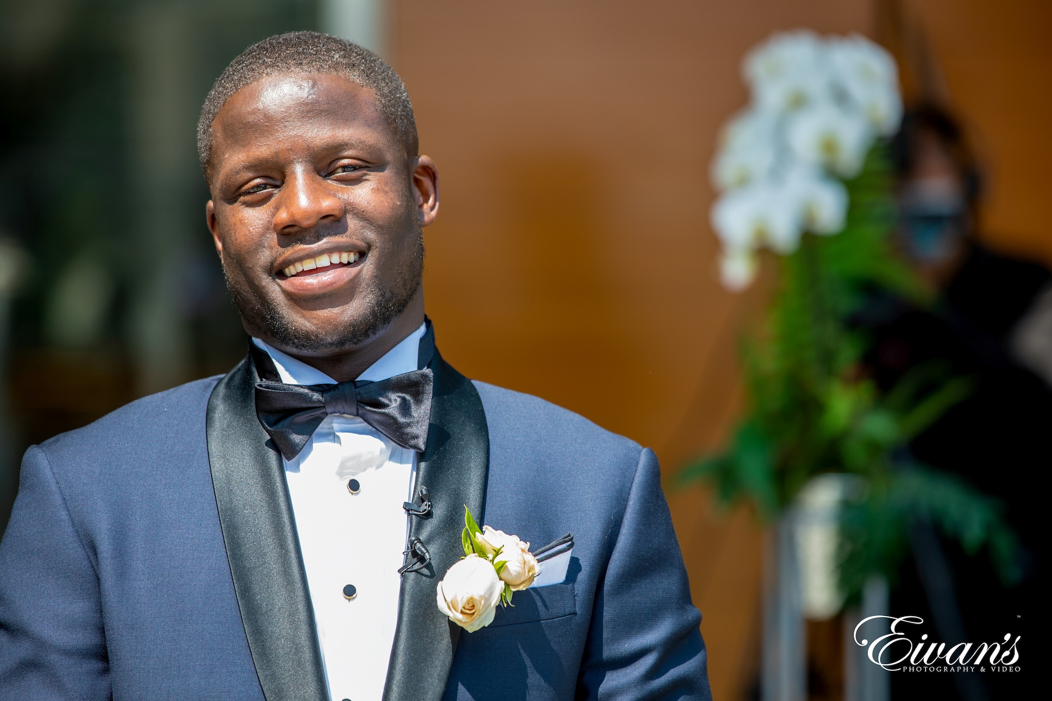 man in blue suit jacket smiling