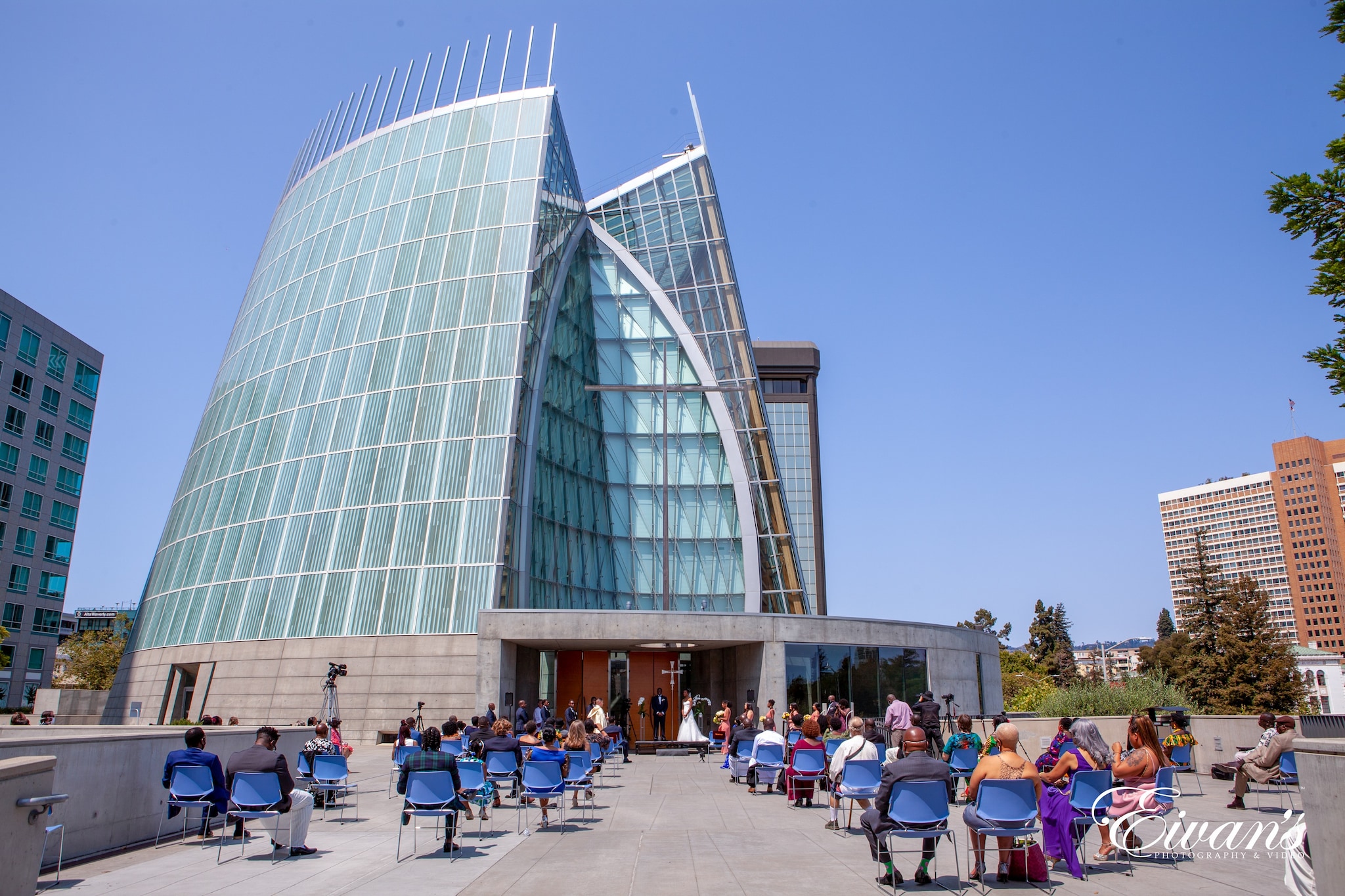 people sitting on chair near glass building during daytime