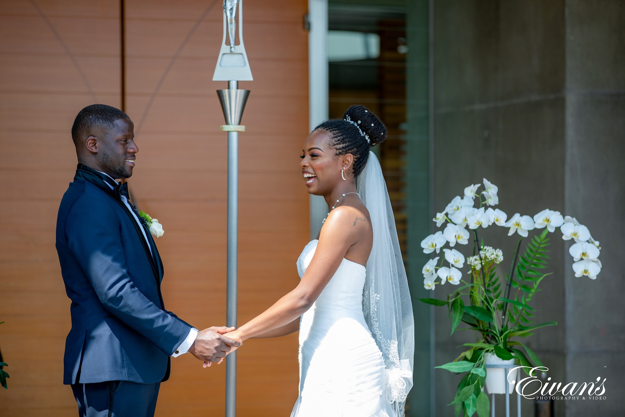 man in blue suit jacket holding woman in white dress