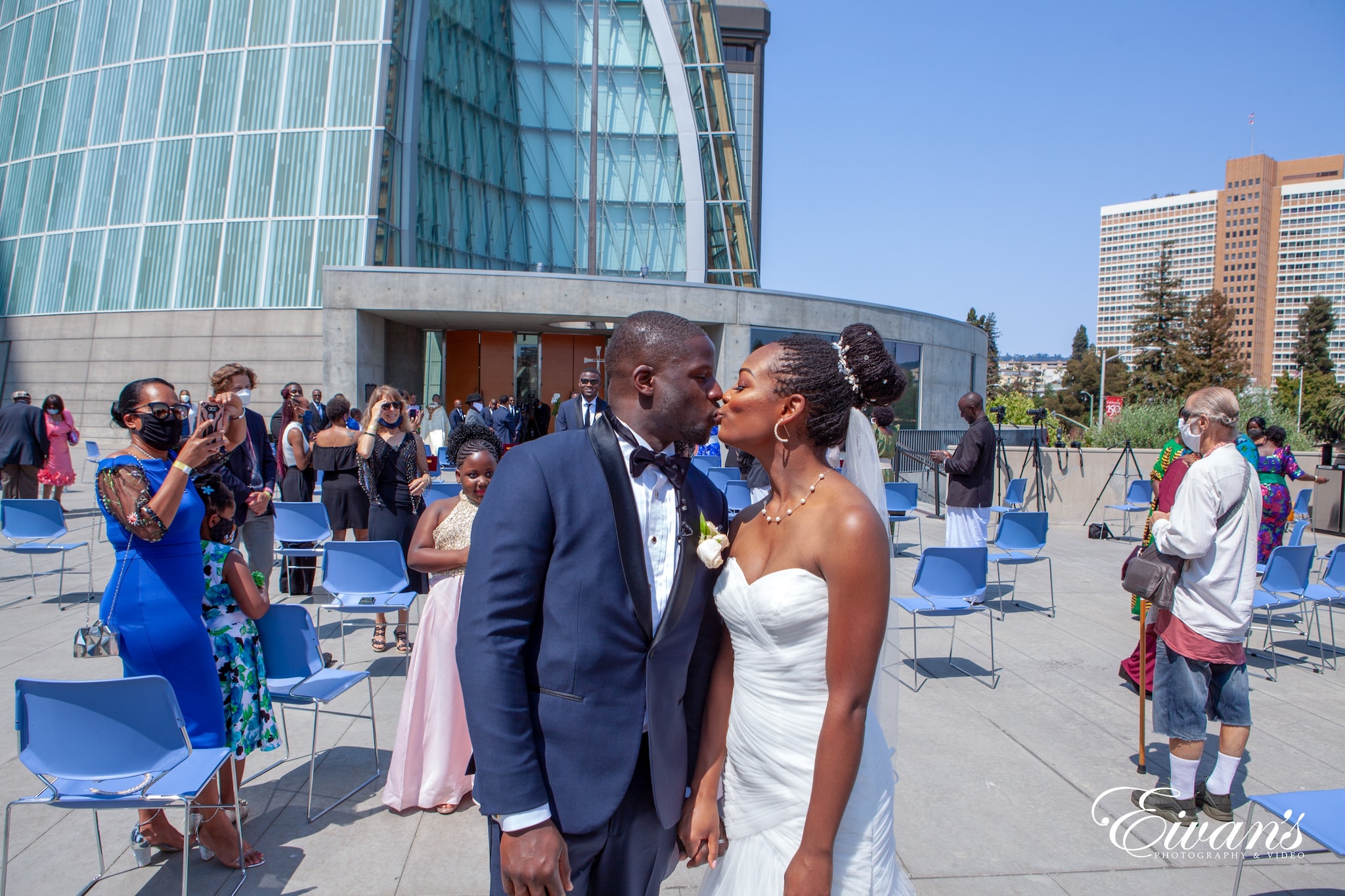 man in blue suit standing beside woman in white tube dress during daytime