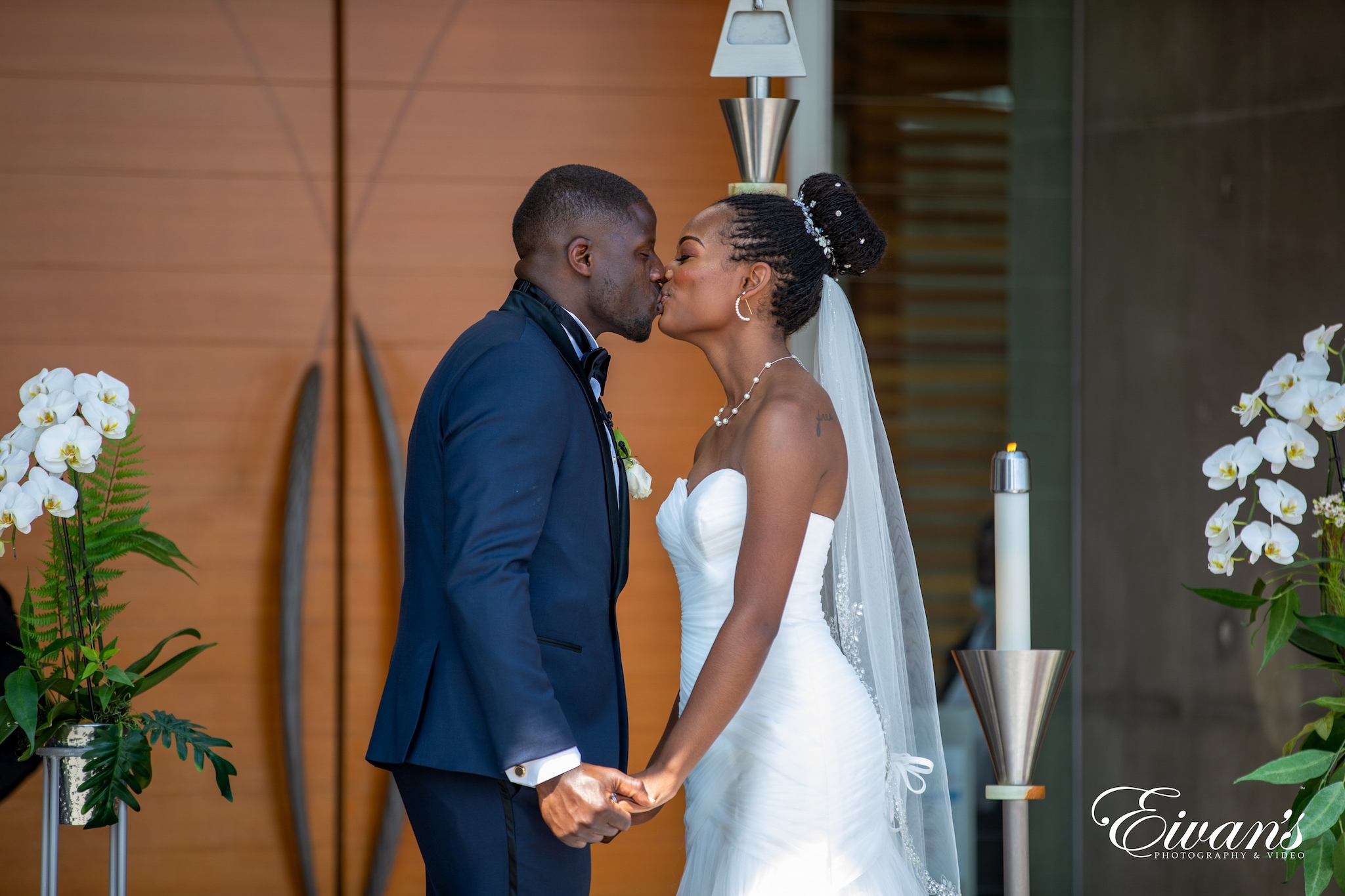 man in black suit standing beside woman in white wedding dress