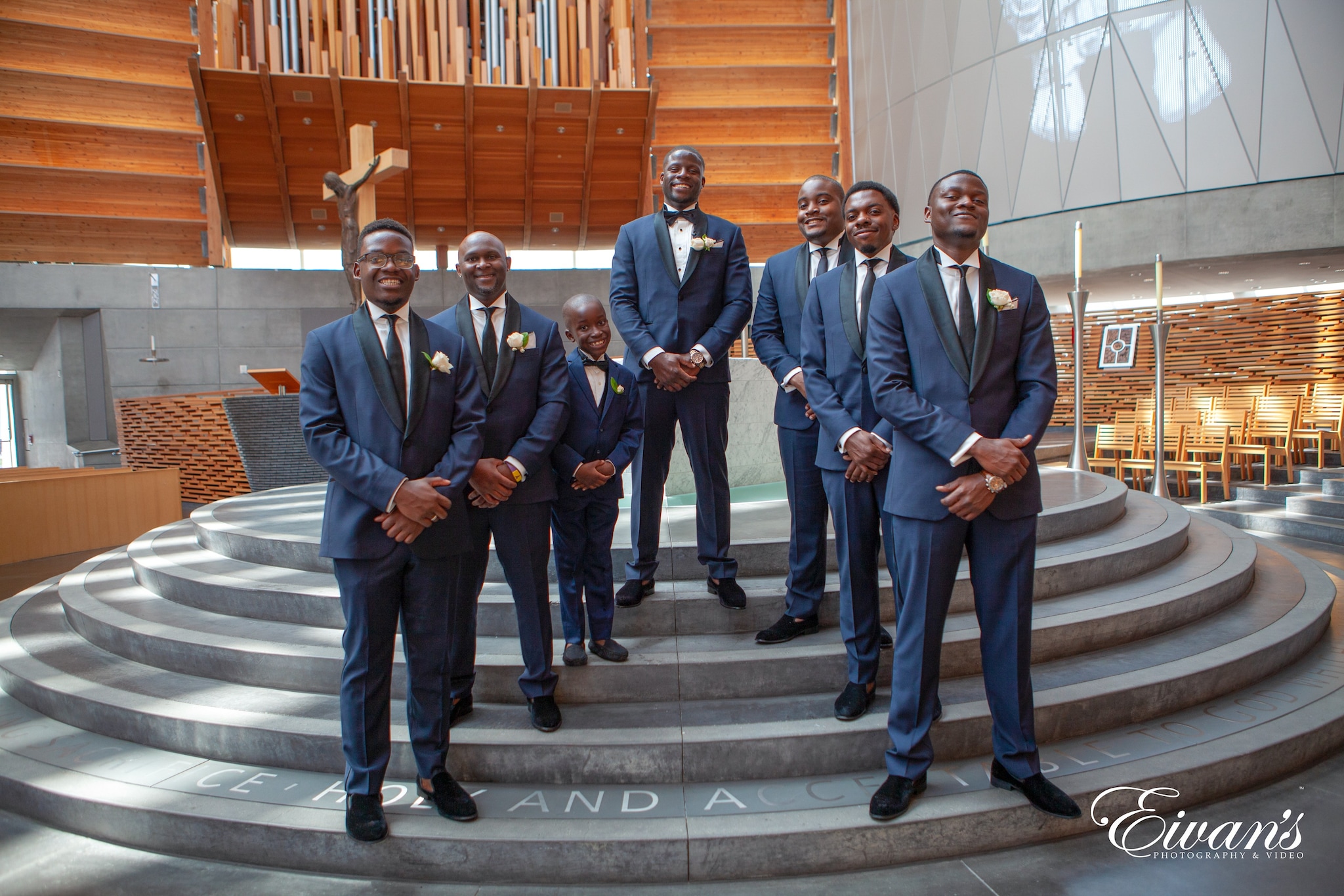 3 men in blue suit standing on white staircase