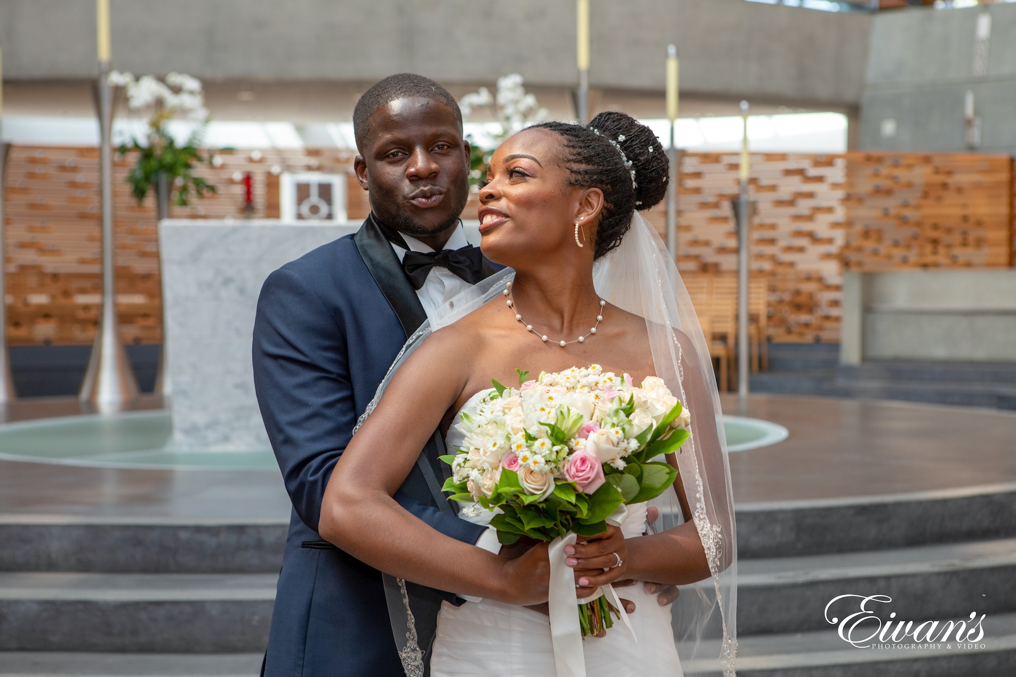 man in black suit jacket holding bouquet of flowers