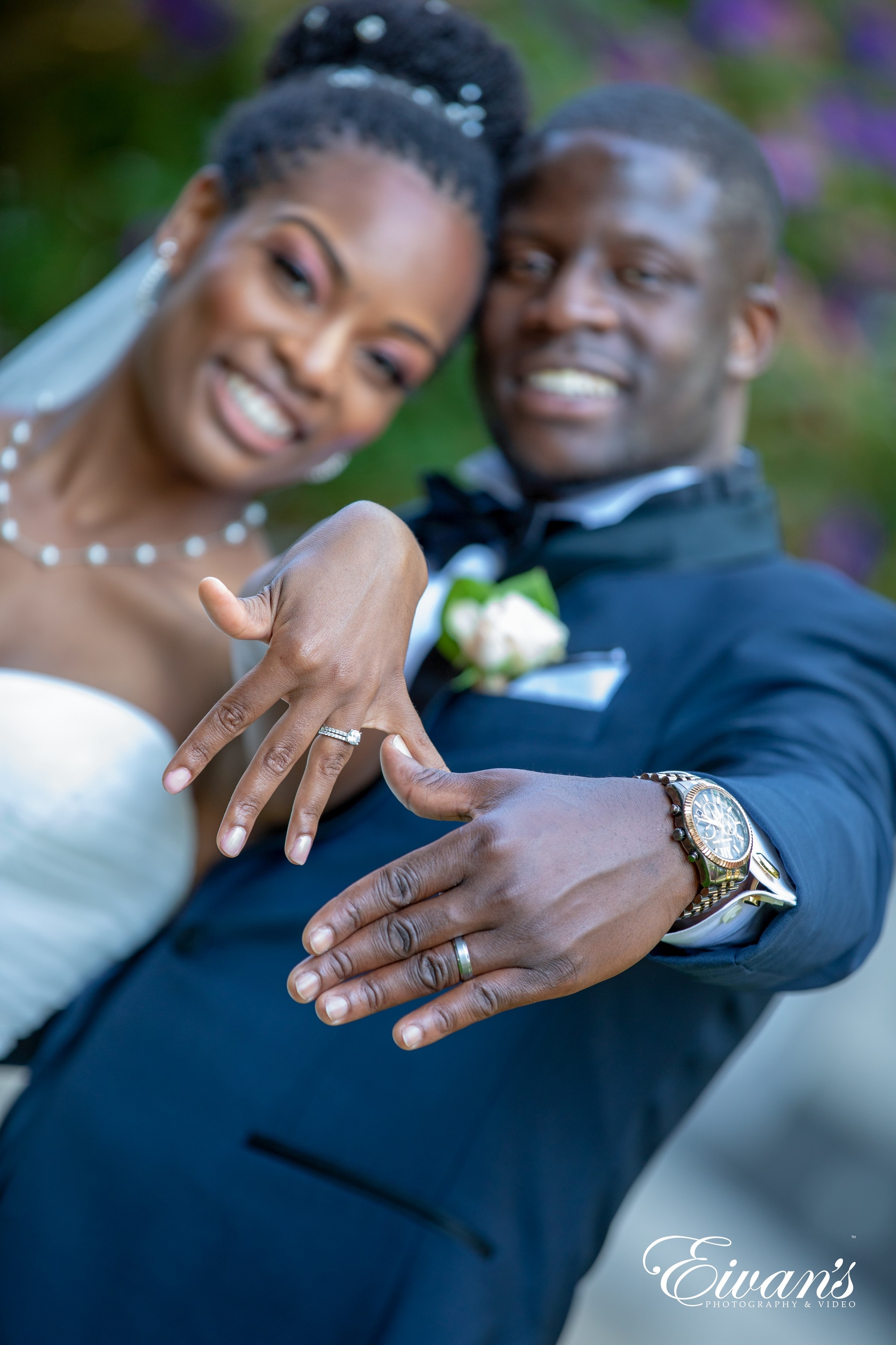 man in blue suit jacket hugging woman in white dress