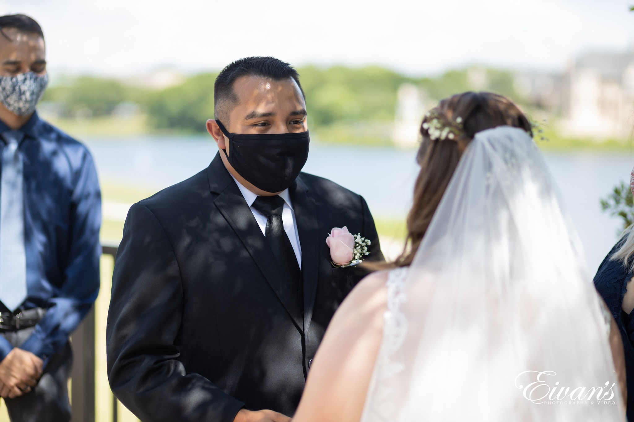 man in black suit jacket and woman in white wedding dress