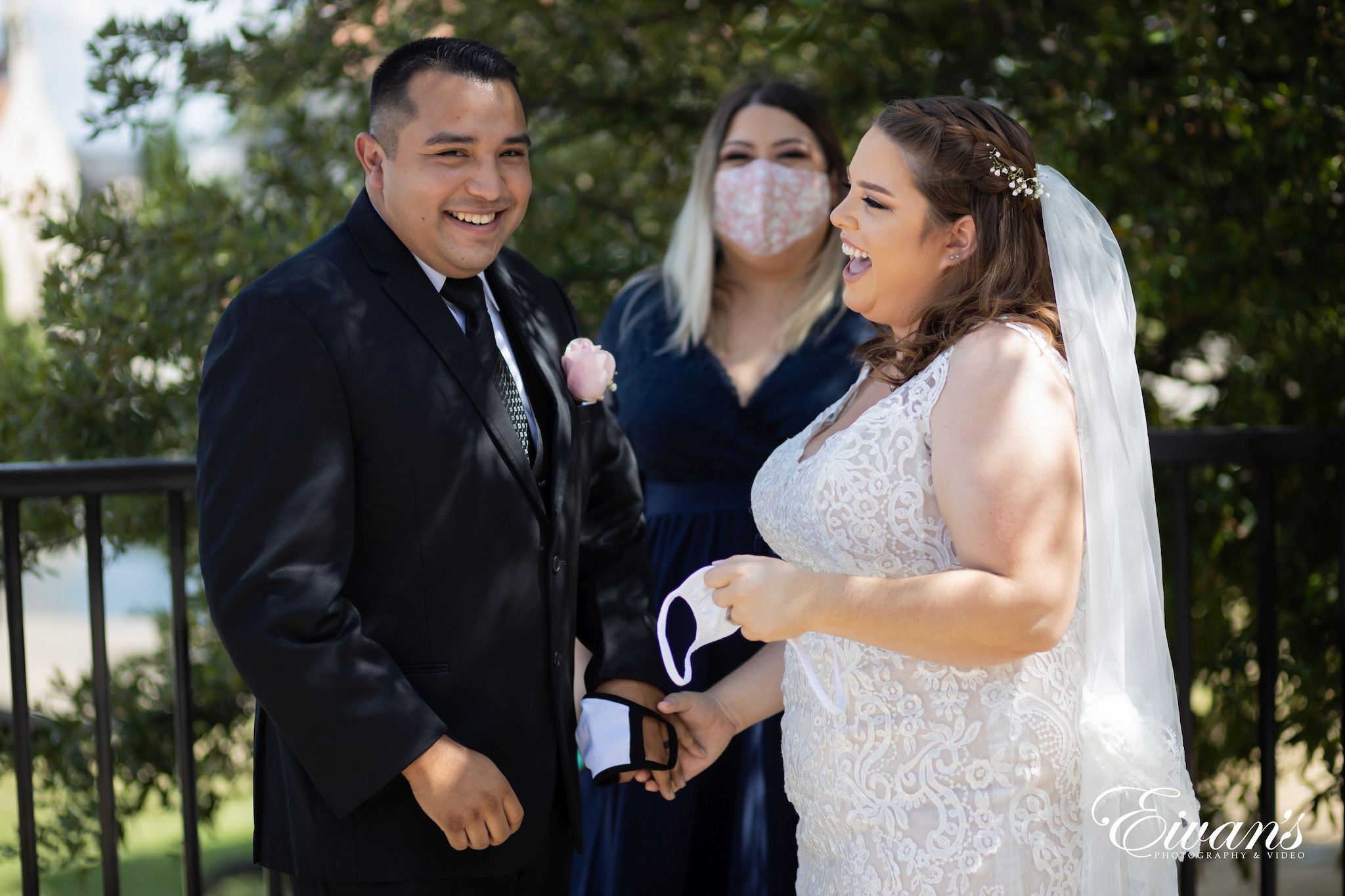 man in black suit jacket beside woman in white floral lace sleeveless dress