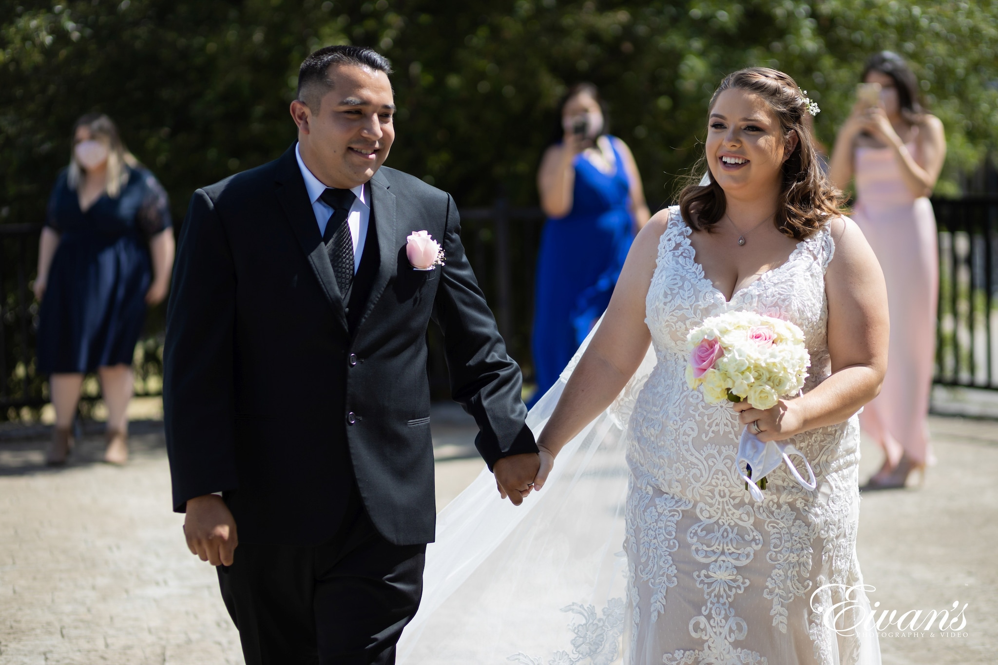 woman in white wedding dress holding bouquet of flowers