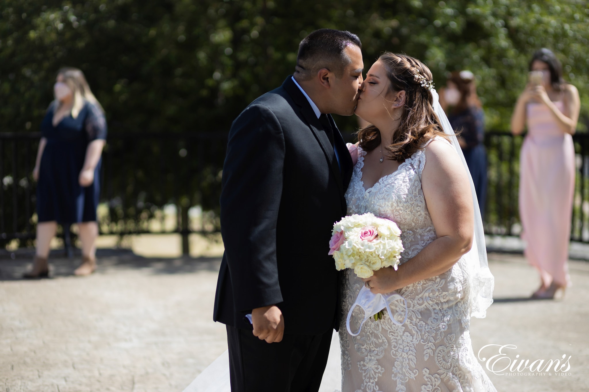 man in black suit and woman in white wedding dress
