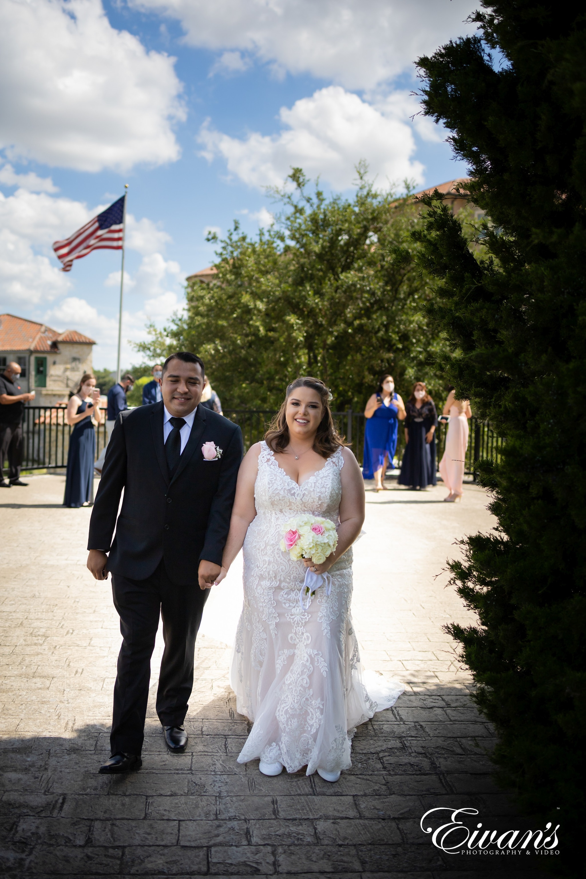 woman in white wedding dress standing beside man in black suit